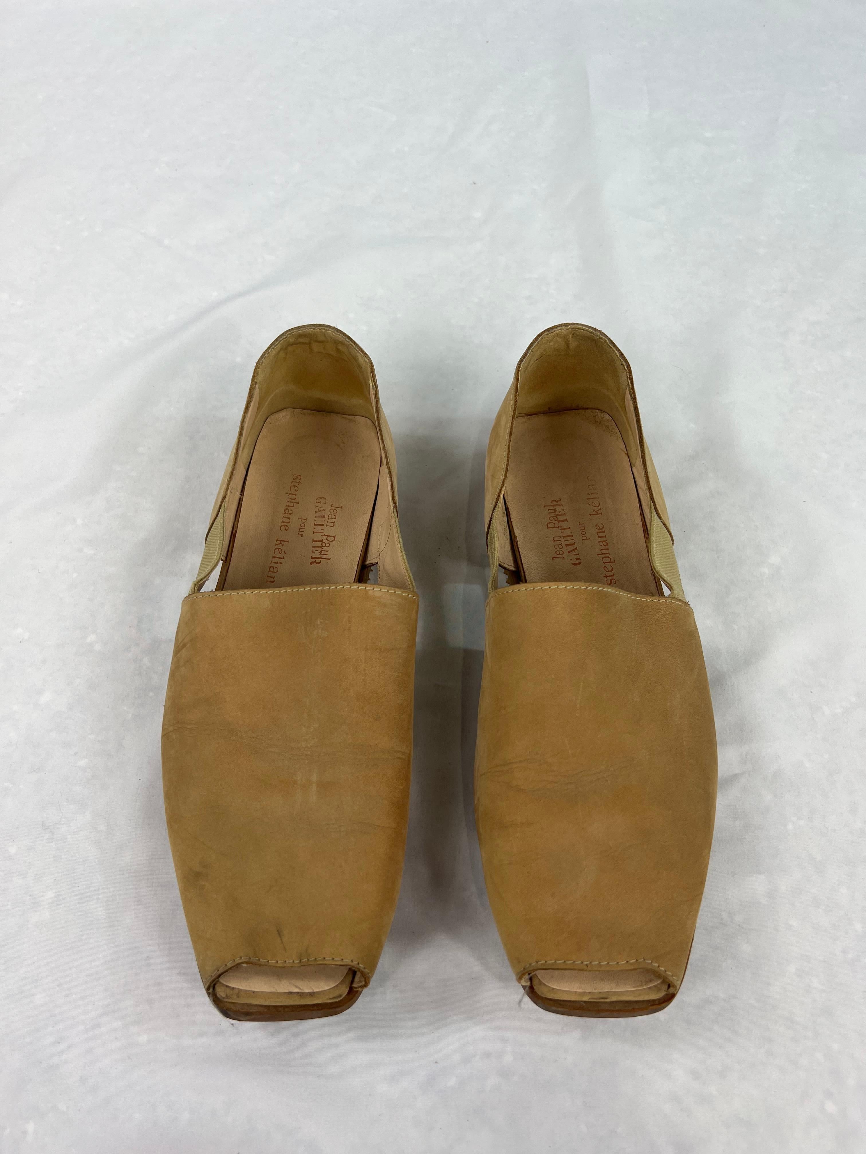 Product details:

The shoes feature camel/ tan color, open toe with side elastic detail and flat style.