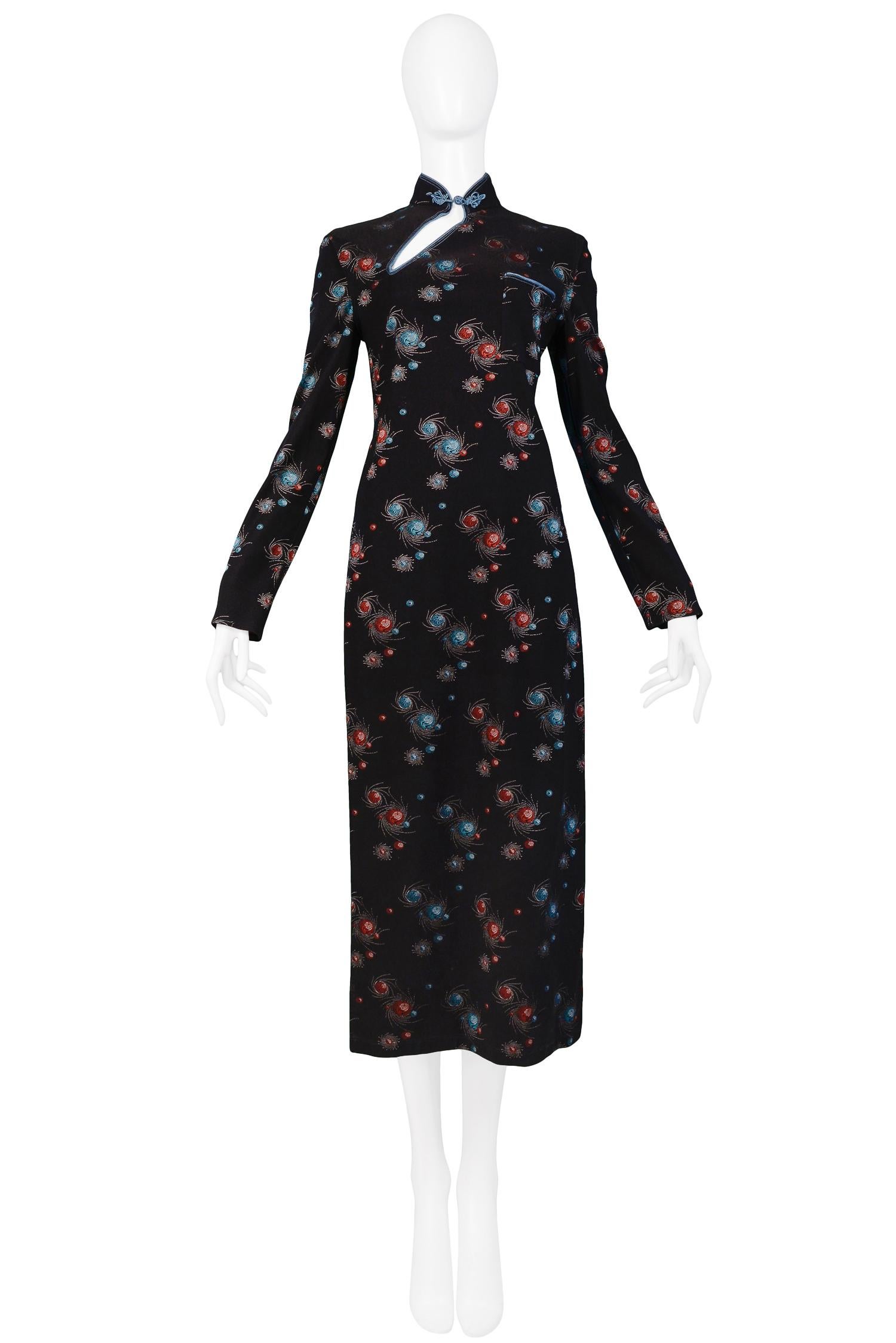 Vintage Jean Paul Gaultier black nylon long sleeve dress featuring an all over blue & red galaxy print, Mandarin collar, abstract keyhole with frog closure at neck and slits from the hem to waist at each sides. From the 1994 Collection.

Condition: