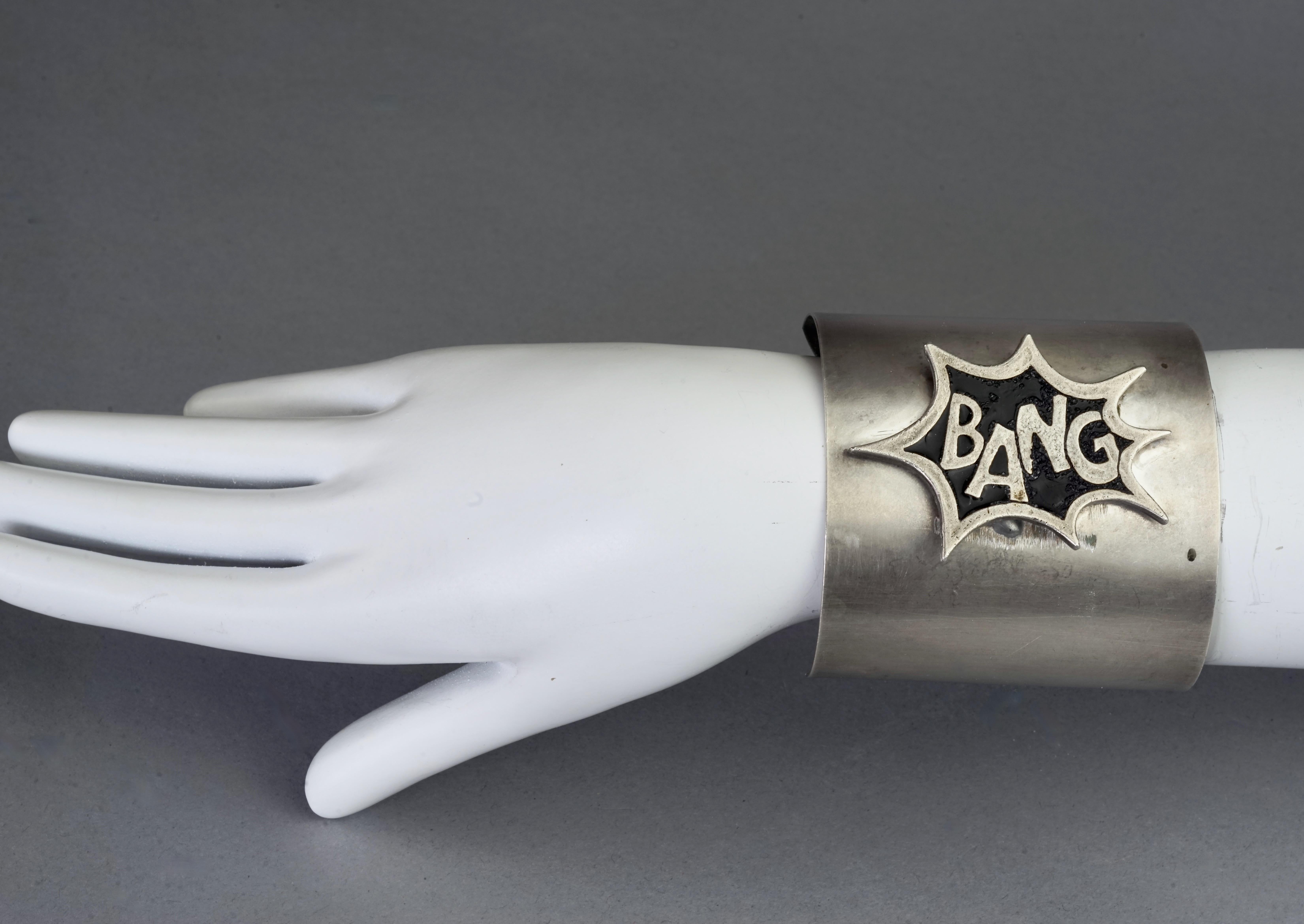 Vintage JEAN PAUL GAULTIER Cartoon Explosion Bang Enamel Silver Cuff Bracelet

Measurements:
Height: 2.56 inches (6.5 cm)
Inner Circumference: 6.30 inches (16 cm) opening included

Features:
- 100% Authentic JEAN PAUL GAULTIER.
- Silver cuff