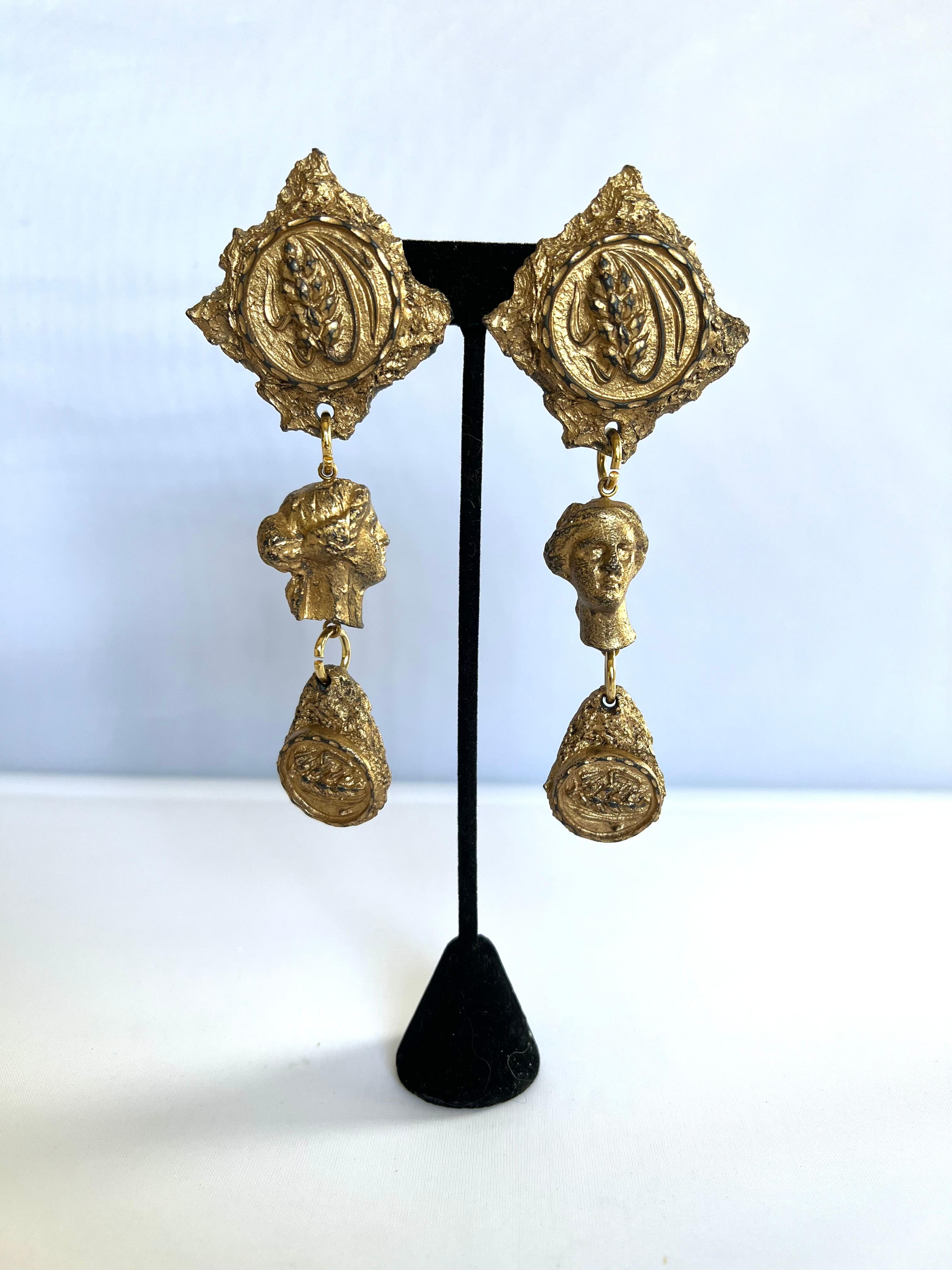 Vintage black and gold lacquer medallion and face clip-on earrings (samples used for defile) by Jean Paul Gaultier, circa 1990. 