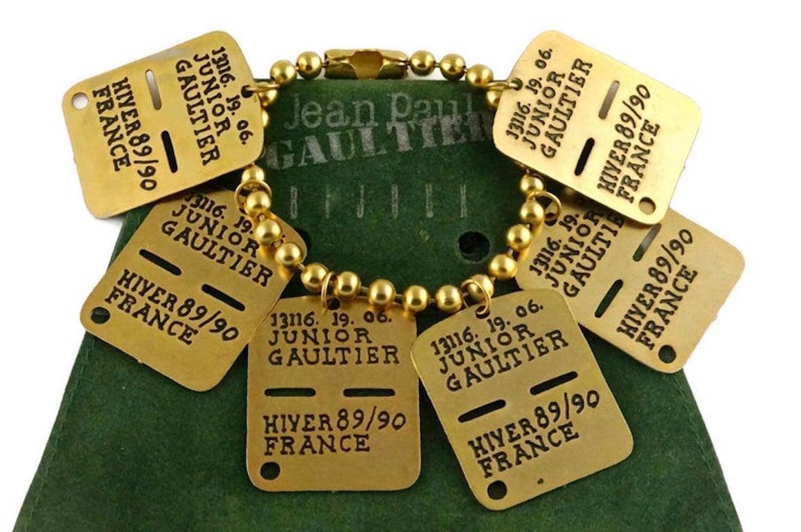 Vintage JEAN PAUL GAULTIER Dog Tag Charm Bracelet

Measurements:
Height: 2 inches
Wearable Length: 7 6/8 inches

Features:
- 100% Authentic JEAN PAUL GAULTIER.
- Massive dog tags with engraved 13116.19.06. JUNIOR GAULTIER HIVER 89/90 FRANCE.
- Chain