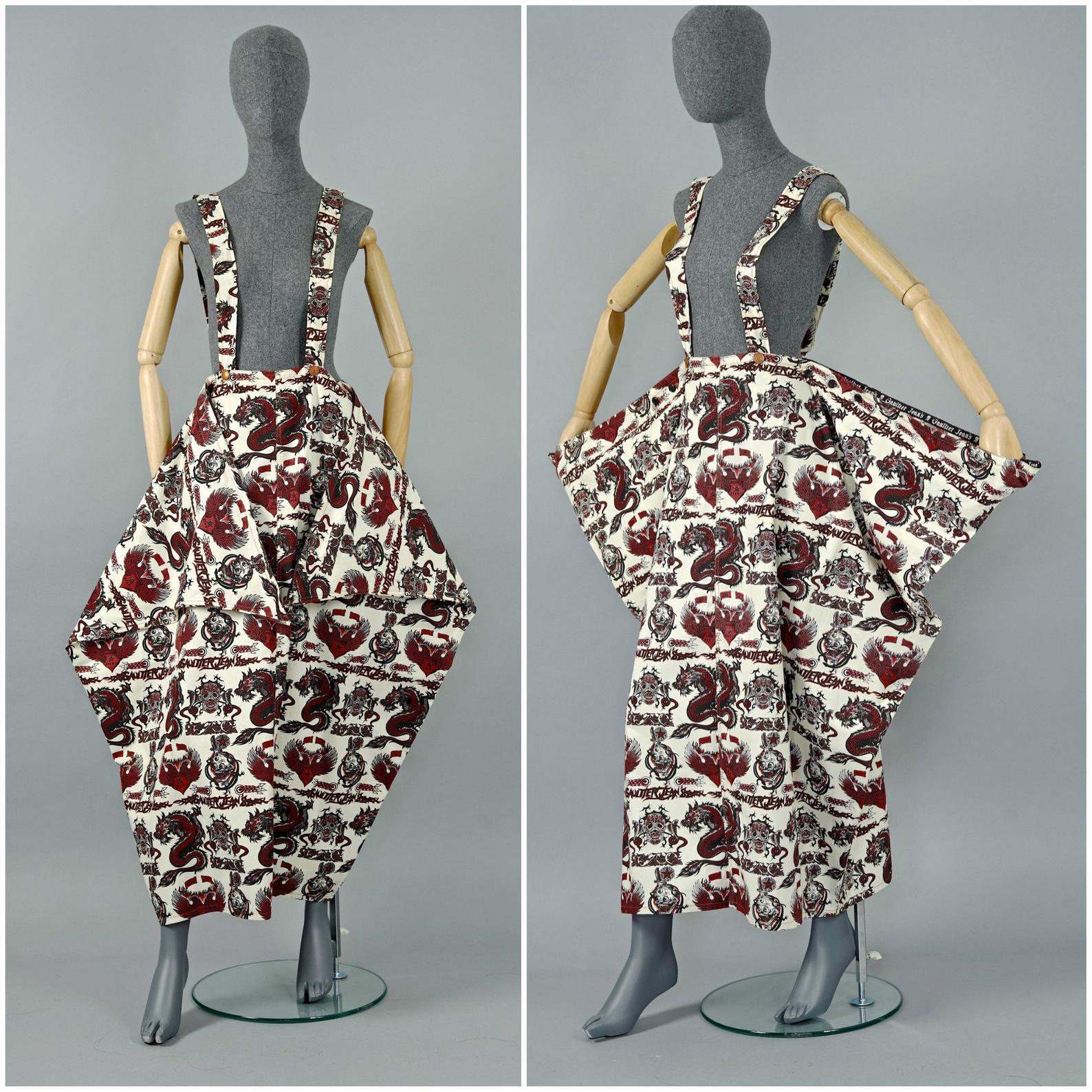 Vintage JEAN PAUL GAULTIER Dragon Skull Eagle Tattoo Print Sarong Suspender Skirt

Measurements taken laid flat, please double waist and hips:
Waist: 11.41 inches to 16.14 inches (29 cm to 41 cm)
Hips: FREE
Straps: 31.10 inches to 33 inches (79 cm