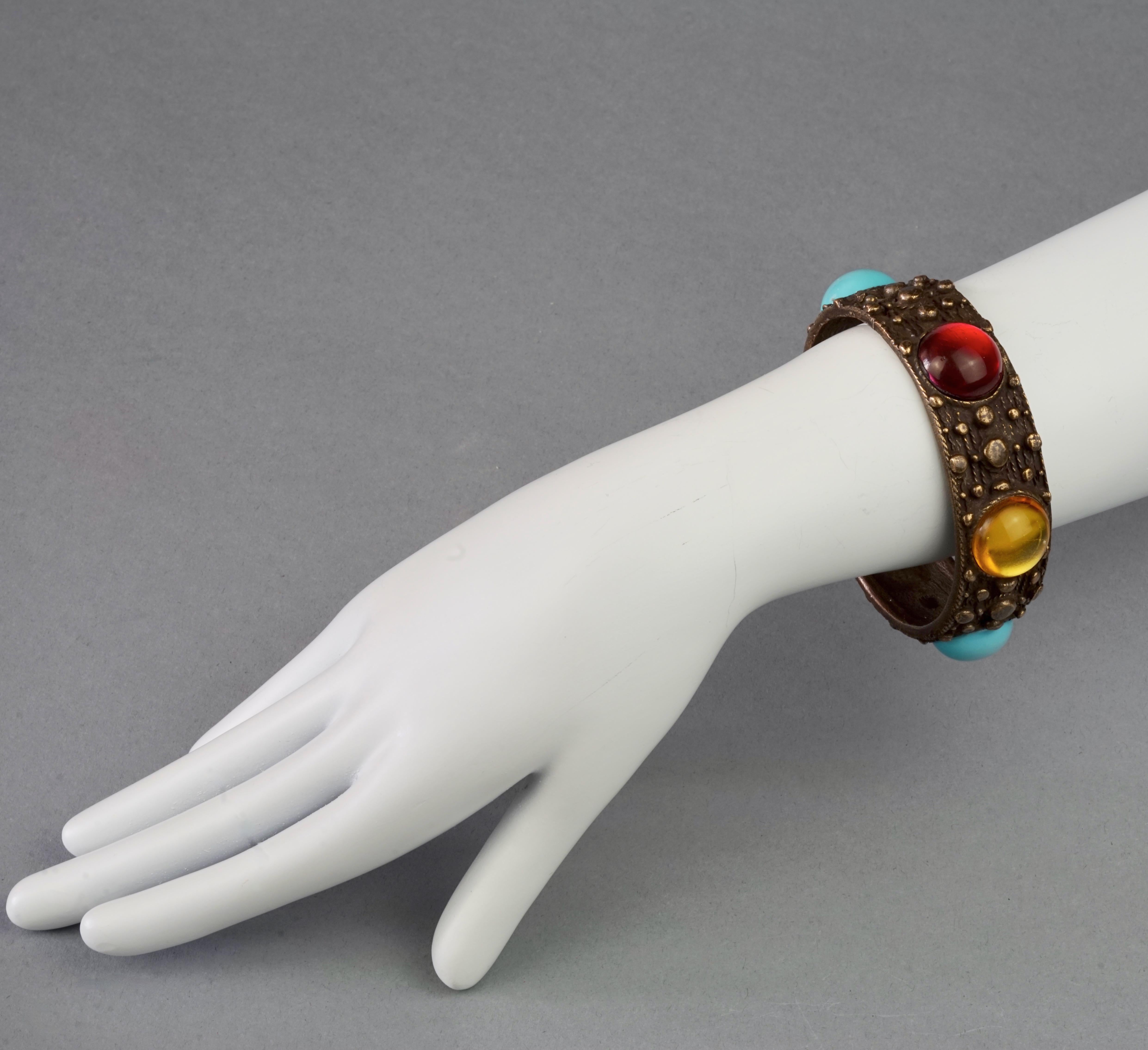Vintage JEAN PAUL GAULTIER Ethnic Glass Cabochons Cuff Bracelet

Measurements:
Height: 0.86 inch (2.2 cm)
Inner Circumference: 8.18 inches (20.8 cm)

Features:
- 100% Authentic JEAN PAUL GAULTIER.
- Ethnic style cuff bracelet with multicolour glass
