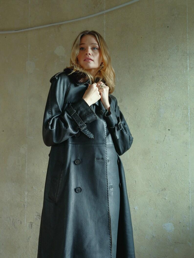 Vintage Jean Paul Gaultier Femme  Black Leather Trench Coat with detachable fur details. 
Dont have the words for this. 
Most incredible construction, beautiful soft leather, wide chunky top stitch and matching belt detail. 
Bright purple silk