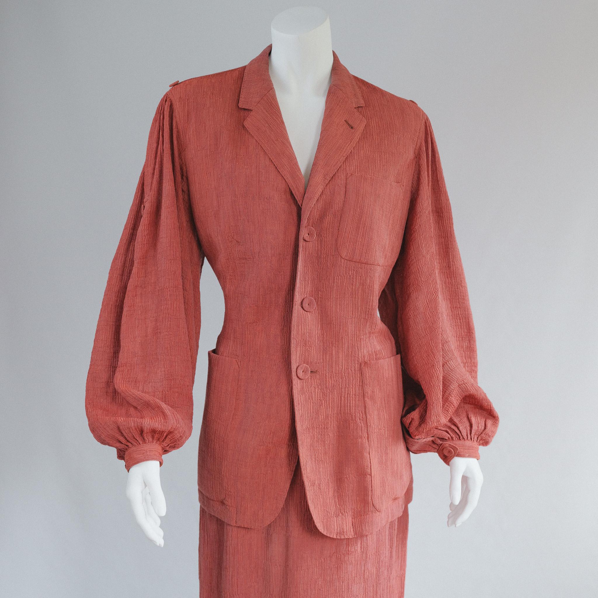 Vintage Jean Paul Gaultier Femme Brick Red Pliss Skirt Suit 
early 90s vintage Iconic and collectible
Dusty red maroon pliss rayon 

Simple blazer with over sized sleeve, full length skirt with beautiful pleated skirt detail. 
Good Vintage