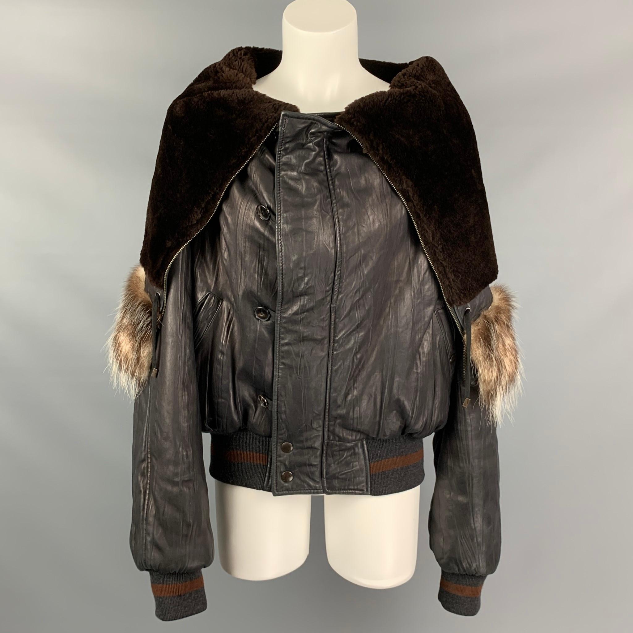 Vintage JEAN PAUL GAULTIER FEMME jacket comes in a black sheep skin leather featuring a turtleneck fur collar, ribbed hem, front pockets, sleeve pocket detail, and a zip & buttoned closure. Made in Italy.

Very Good Pre-Owned Condition.
Marked: Size