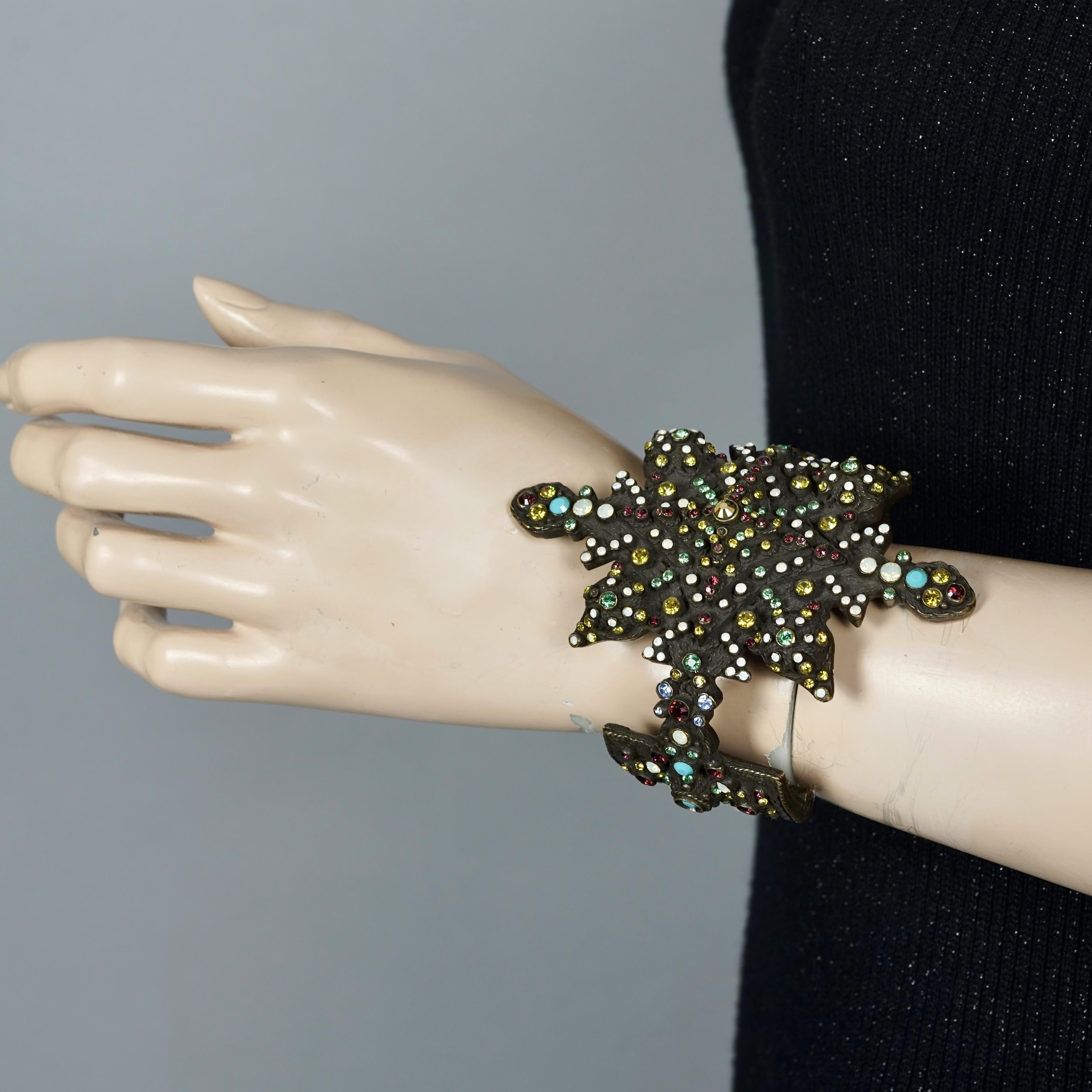 Vintage JEAN PAUL GAULTIER Gothic Jeweled Cuff Bracelet

Measurements:
Height: 3.77 inches (9.6 cm)
Width: 2.91 inches (7.4 cm)
Inner Circumference: 7.99 inches (16.5 cm)

Features:
- 100% Authentic JEAN PAUL GAULTIER.
- Gothic cuff studded with