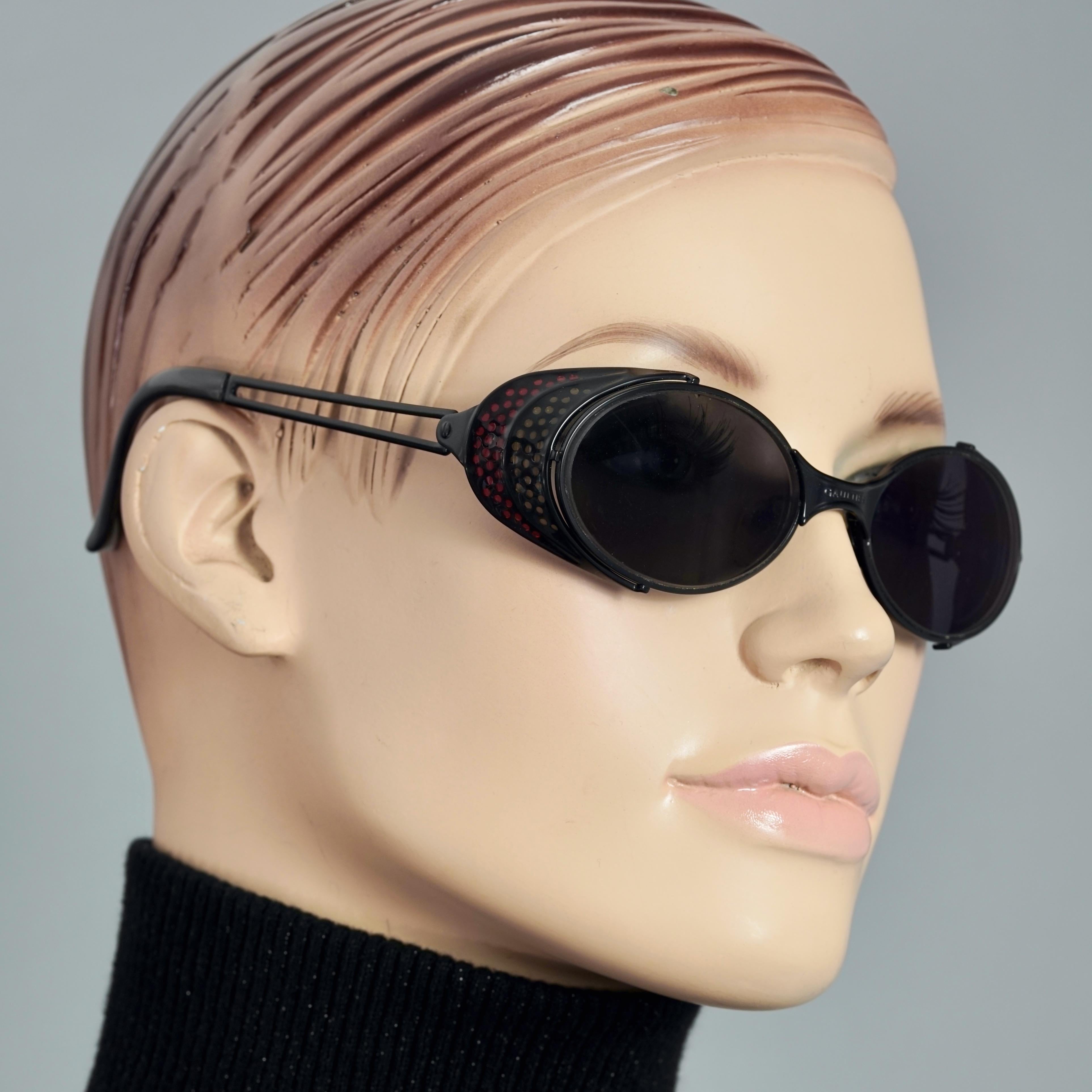 Vintage JEAN PAUL GAULTIER Logo Polka Dot Steampunk Sunglasses

Measurements:
Height: 1.57 inches (4 cm)
Horizontal Width: 5.43 inches (13.8 cm)
Arms: 4.72 inches (12 cm)

Features:
- 100% Authentic JEAN PAUL GAULTIER. 
- Steampunk sunglasses with