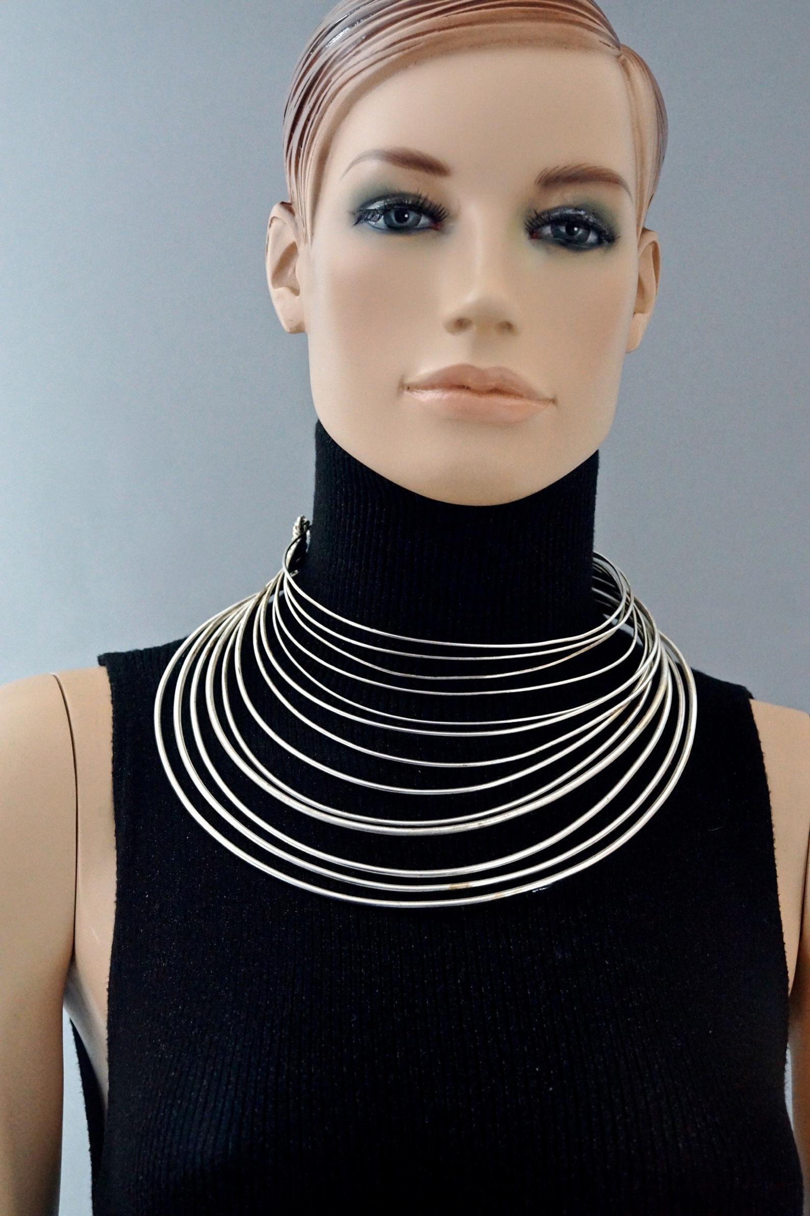 Vintage JEAN PAUL GAULTIER Masai Multi Wire Silver Choker Necklace

Measurements:
Total Wearable Circumference: 15.74 inches (40 cm)
Opening: 4.13 inches (10.5 cm)

Features:
- 100% Authentic JEAN PAUL GAULTIER.
- Multiple layer of rigid wires.
-