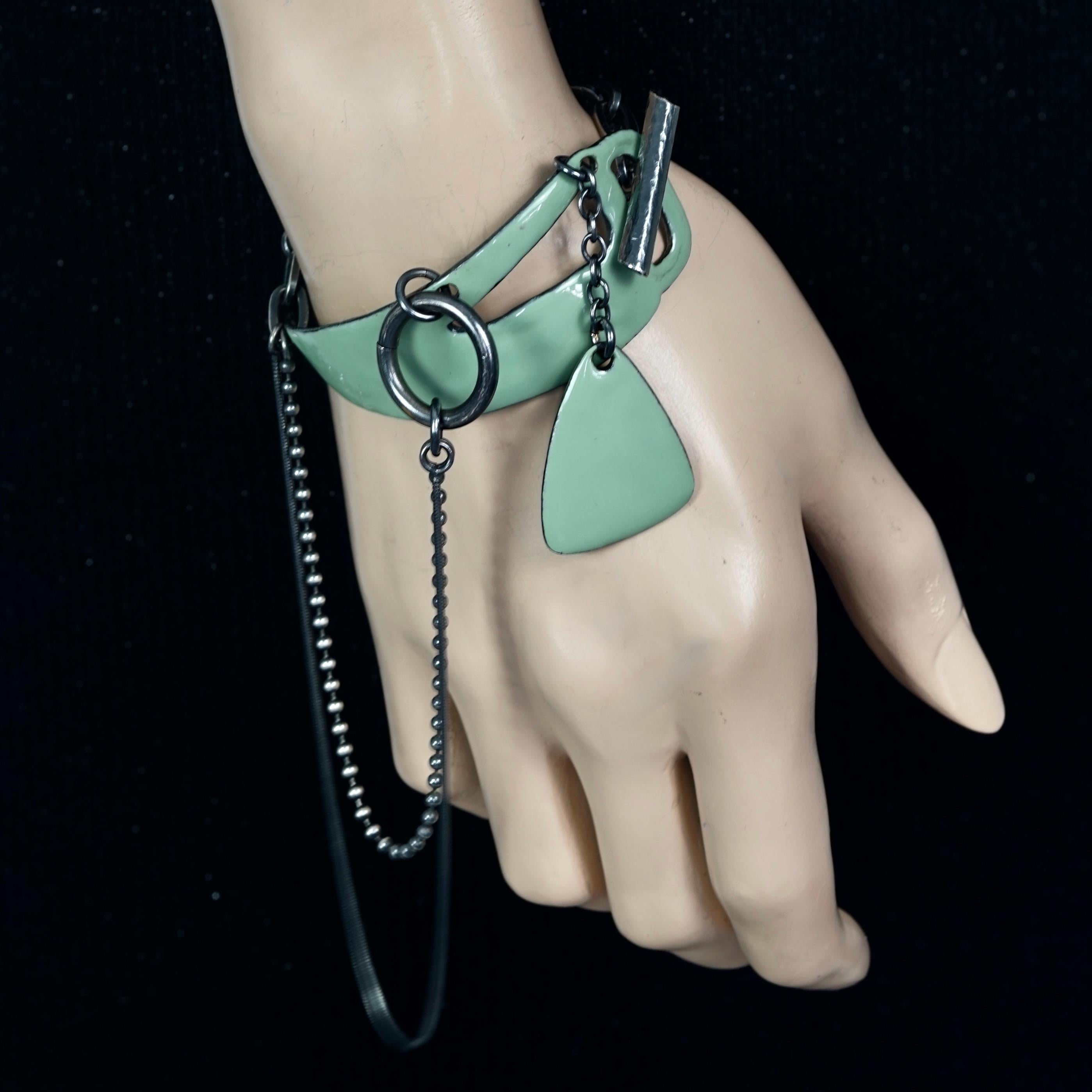 Vintage JEAN PAUL GAULTIER Multi Chain Enamel Bracelet

Measurements:
Wearable Length: 5.70 inches (14.5 cm)

Features:
- 100% Authentic JEAN PAUL GAULTIER.
- Enamel bracelet in jade shade featuring multiple chains.
- Toggle closure.
- Silver tone