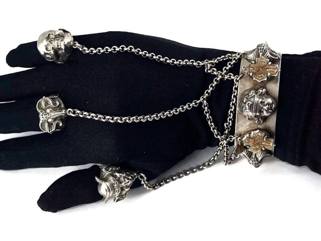 Vintage JEAN PAUL GAULTIER Punk Gothic Chain Knuckle Rings and Cuff

Measurements:
CUFF
Height: 0.98 inch (2.5 cm)
Circumference: 7.16 inches (18.2 cm)
Chain Connectors: 4.52 inches (11.5 cm)

RING
Height: 0.98 inch (2.5 cm)
Sizes: 56 but they are