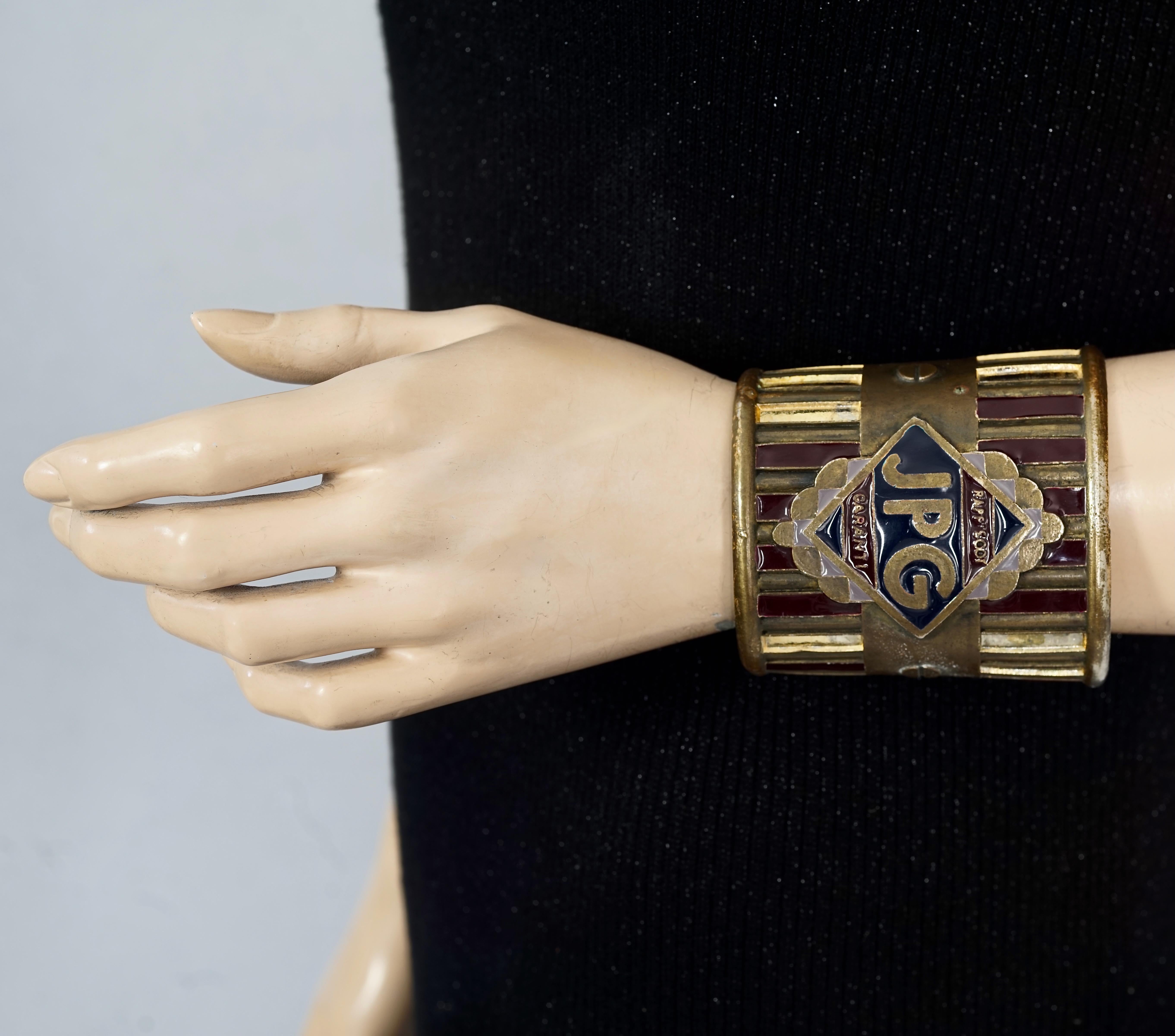 Vintage JEAN PAUL GAULTIER Rapsody Garanti Enamel Rustic Cuff Bracelet

Measurements:
Height: 3.07 inches (7.8 cm)
Inner Circumference: 6.61 inches (16.8 cm) opening included

Features:
- 100% Authentic JEAN PAUL GAULTIER.
- Wide enamel cuff