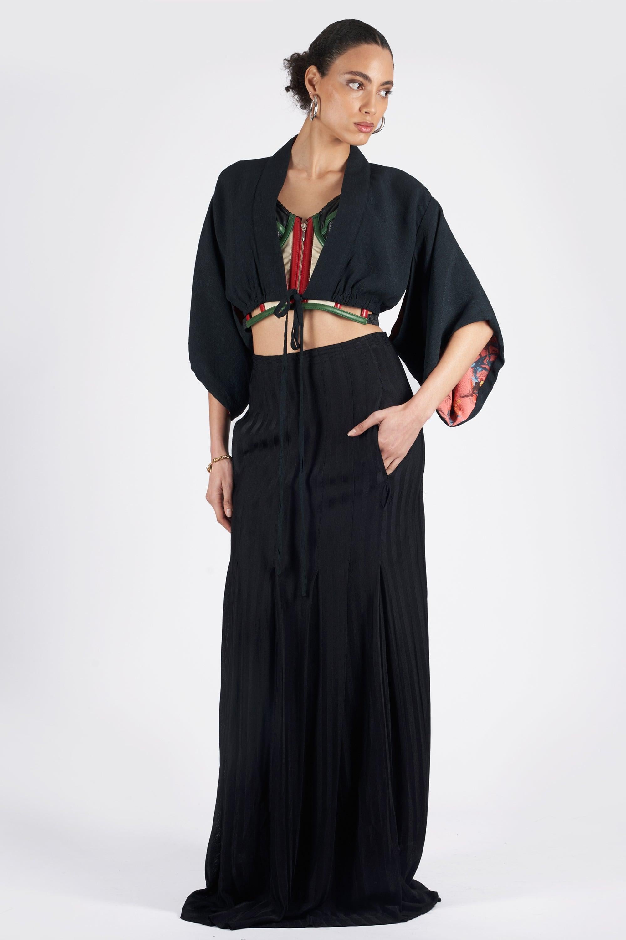 Vintage Jean Paul Gaultier Spring Summer 1999 cropped drawstring kimono. Features a drawstring waist, cropped fit and contrast patterned lining. In excellent vintage condition.
Brand: Jean Paul Gaultier
Size: UK 10
Color: Black
Label size: 40