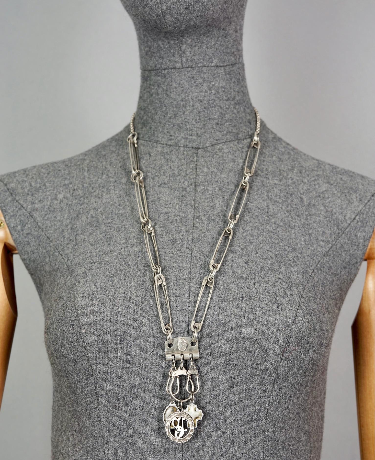 Vintage JEAN PAUL GAULTIER Safety Pin Logo Scapular Charm Necklace

Measurements:
Pendant Drop: 3.15 inches (8 cm)
Wearable Length: 27.56 inches (70 cm)

Features:
- 100% Authentic JEAN PAUL GAULTIER.
- Safety pin links with scapular and JPG