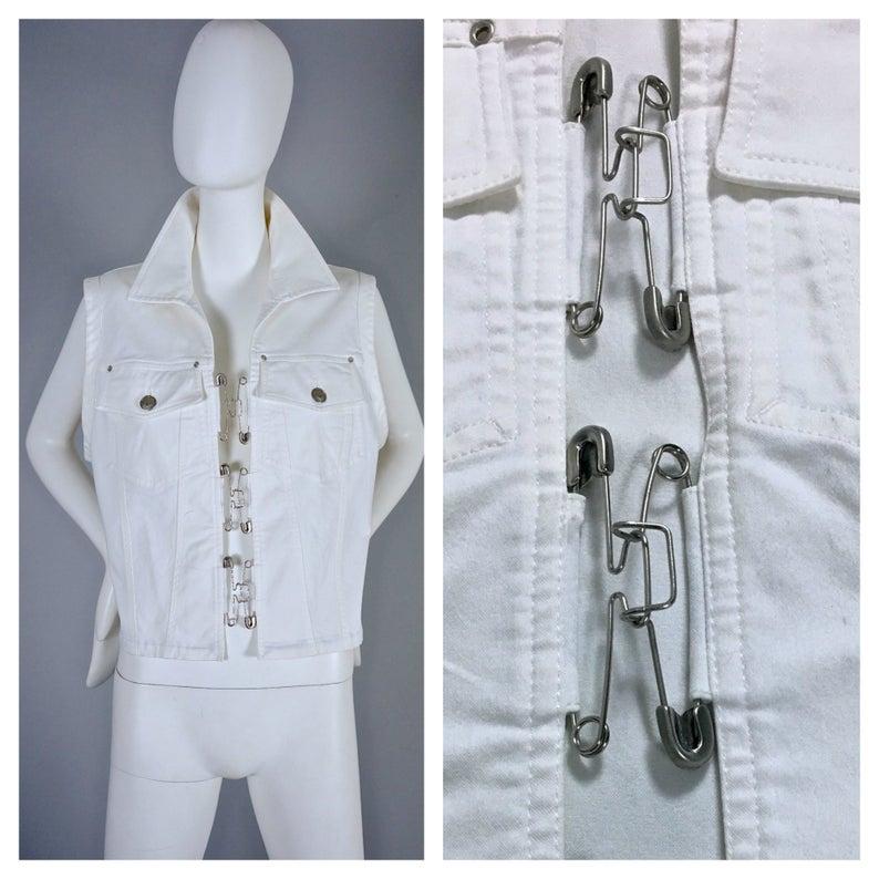 Vintage JEAN PAUL GAULTIER Safety Pin White Denim Vest Jacket

Measurements taken laid flat, please double bust and waist:
Shoulder: 16.14 inches (41 cm)
Bust: 20.07 inches (51 cm)
Hem: 17.91 inches (45.5 cm)
Length: 20.86 inches (53
