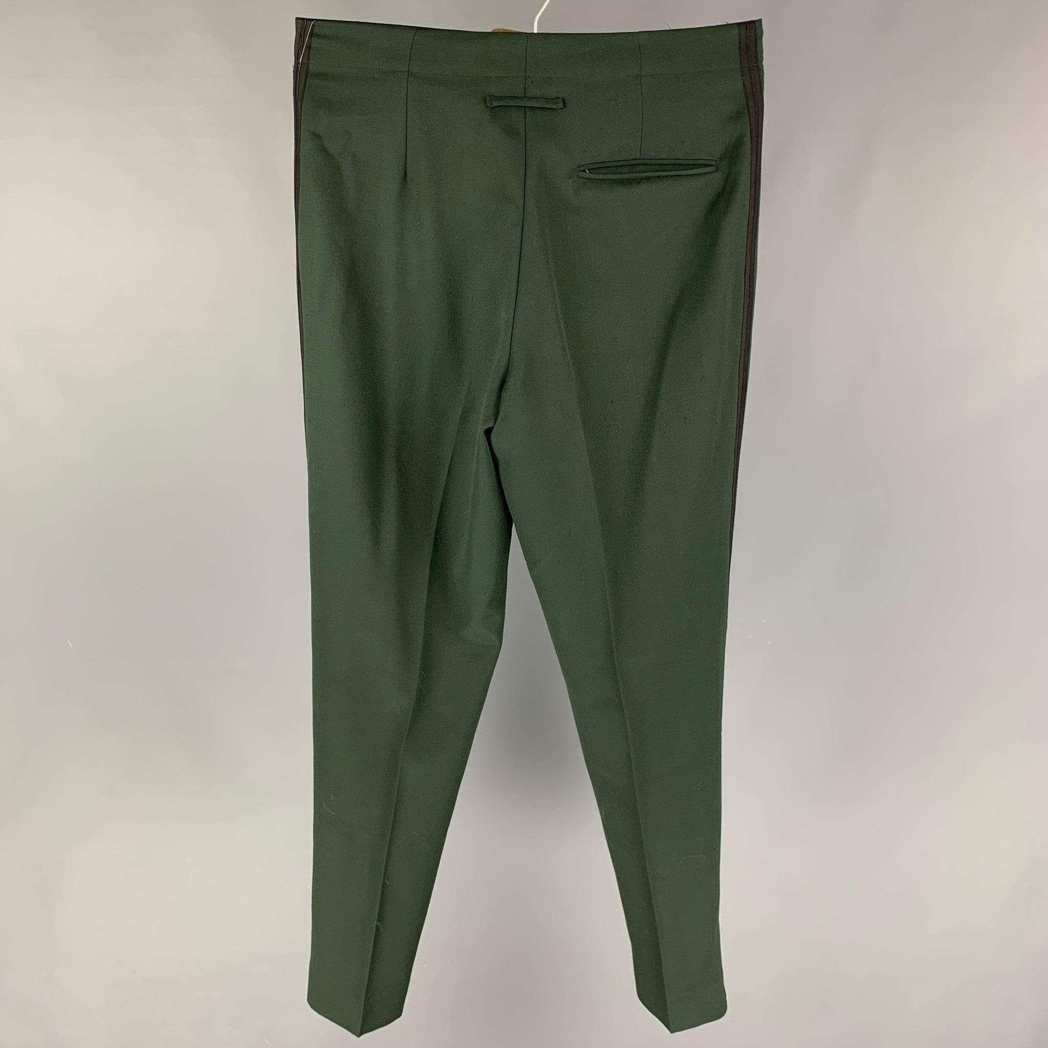 Vintage JEAN PAUL GAULTIER dress pants comes in a forest green material featuring a high waist, side stripe, front tab, and a zip fly closure. Made in Italy.
Good
Pre-Owned Condition. Minor tear at front. 

Marked:   50 

Measurements: 
  Waist: 34