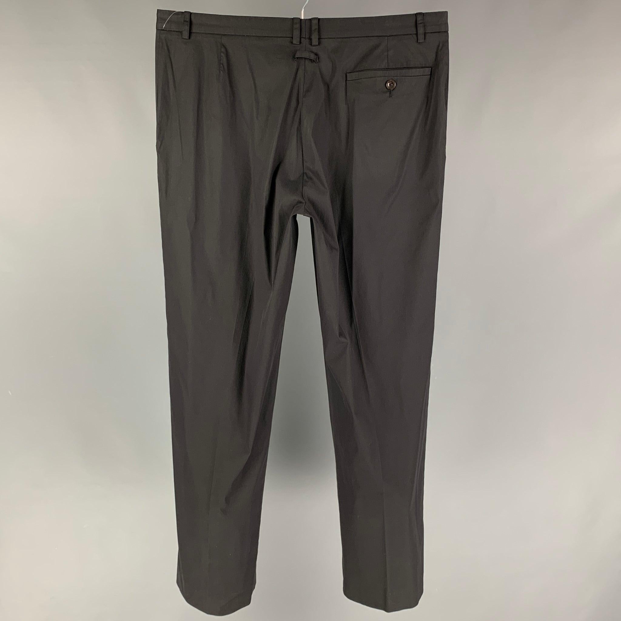 Vintage JEAN PAUL GAULTIER dress pants comes in a black wool / polyester featuring a flat front, front tab, and a zip fly closure.
Very Good
Pre-Owned Condition. 

Marked:   I 52 / E 52 / GB 42 / USA 36 

Measurements: 
  Waist: 36 inches  Rise: