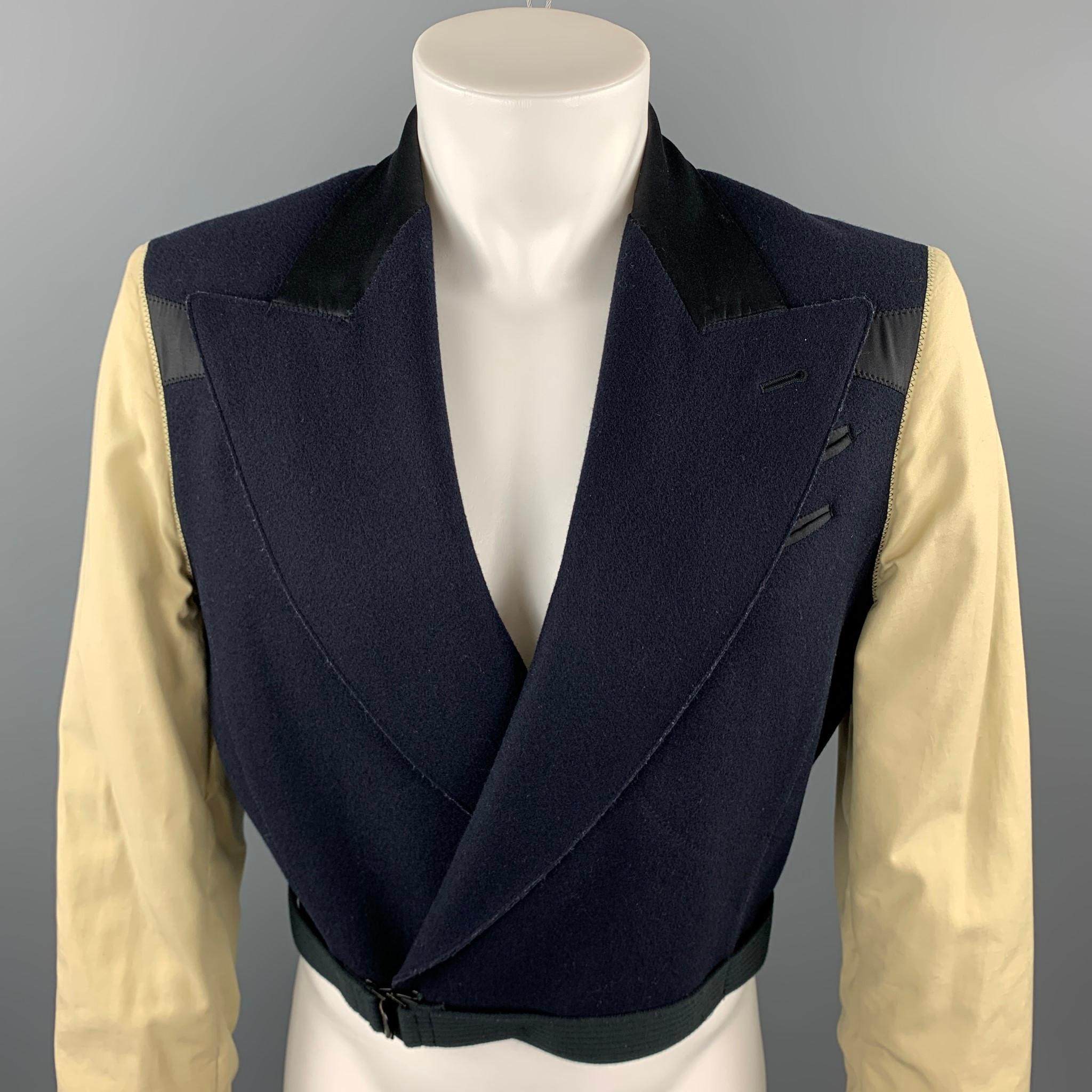 Vintage JEAN PAUL GAULTIER jacket comes in a navy & beige mixed fabric wool featuring a cropped style, peak lapel, strap detail, and a hook & eye closure. Made in Italy. 

Very Good Pre-Owned Condition.
Marked: IT 46

Measurements:

Shoulder: 18 in.