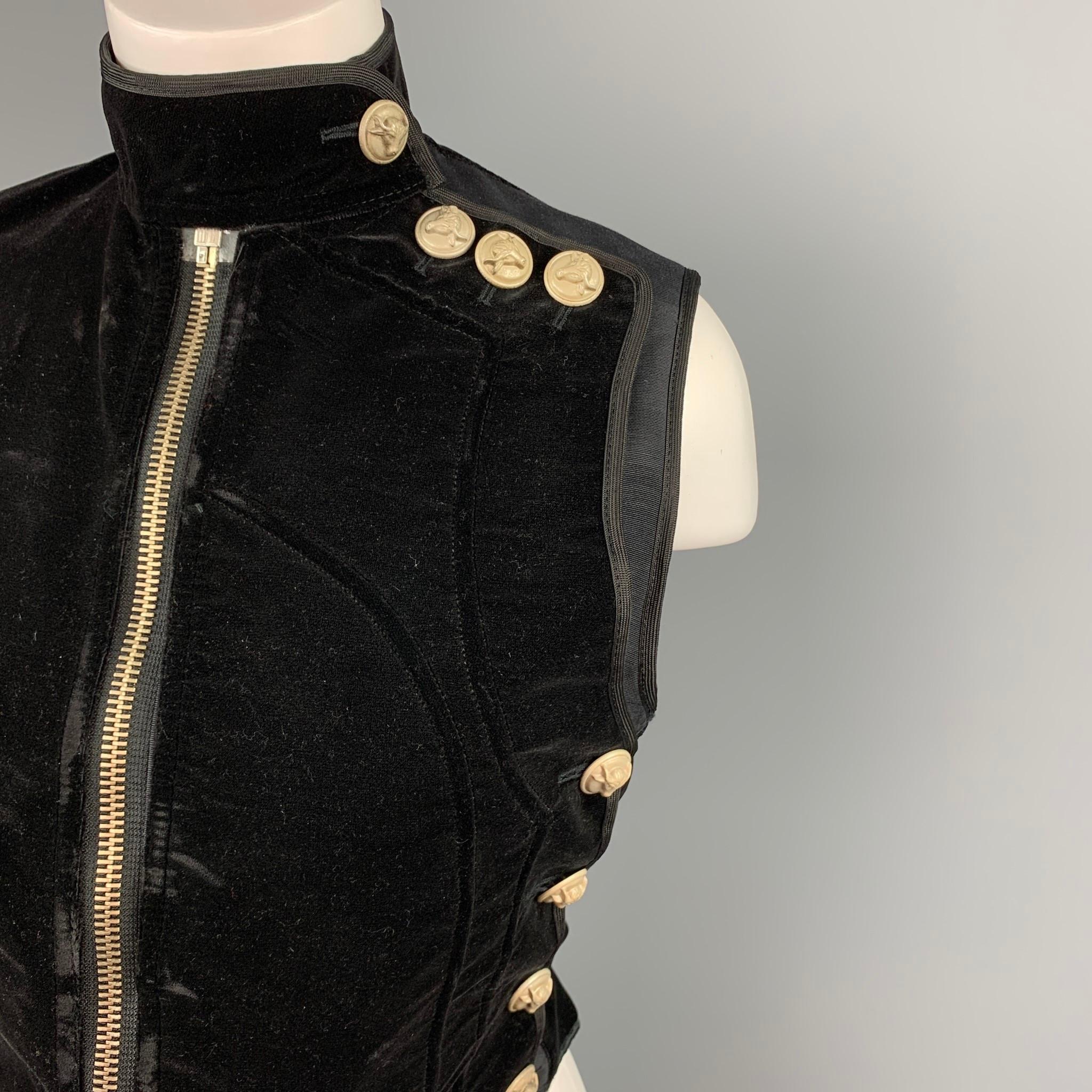 Vintage JEAN PAUL GAULTIER vest comes in a black velvet with a full liner featuring a strap collar detail, bull head buttons, back strap, and a upside down zip up closure.

Very Good Pre-Owned Condition.
Marked: IT 42

Measurements:

Shoulder: 14.5