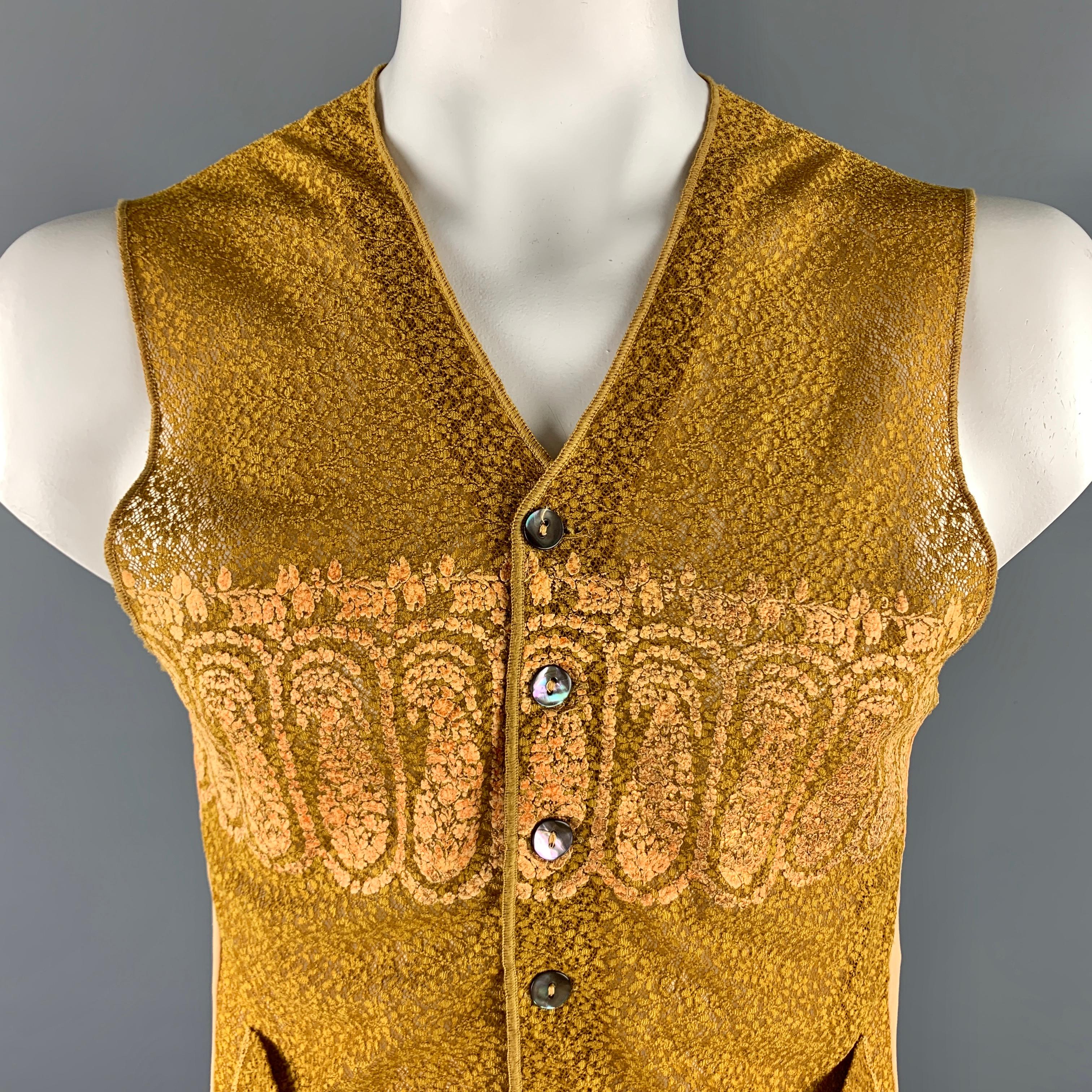 Vintage JEAN PAUL GAULTIER vest comes in gold and beige lace and mesh polyamide material, featuring a gold lace pale at front and shoulder, patch pockets, embellishment at chest, buttoned. Made in Italy.

Excellent Pre-Owned Condition.
Marked: