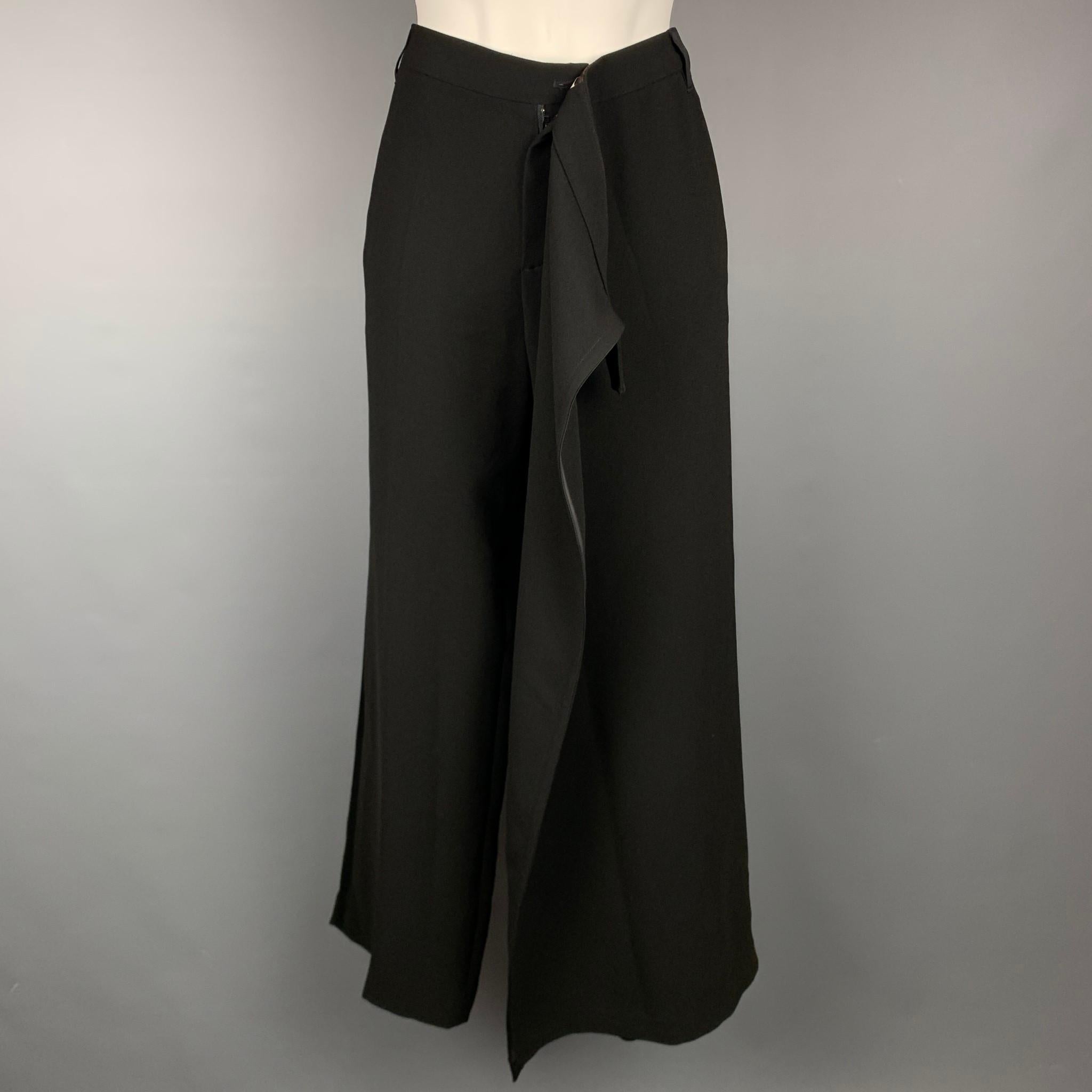 Vintage JEAN PAUL GAULTIER dress pants comes in a black triacetate blend with a skirt panel design, wide leg, side button detail, front tab, and a zip fly closure. Made in Italy.

Very Good Pre-Owned Condition.
Marked: S

Measurements:

Waist: 32