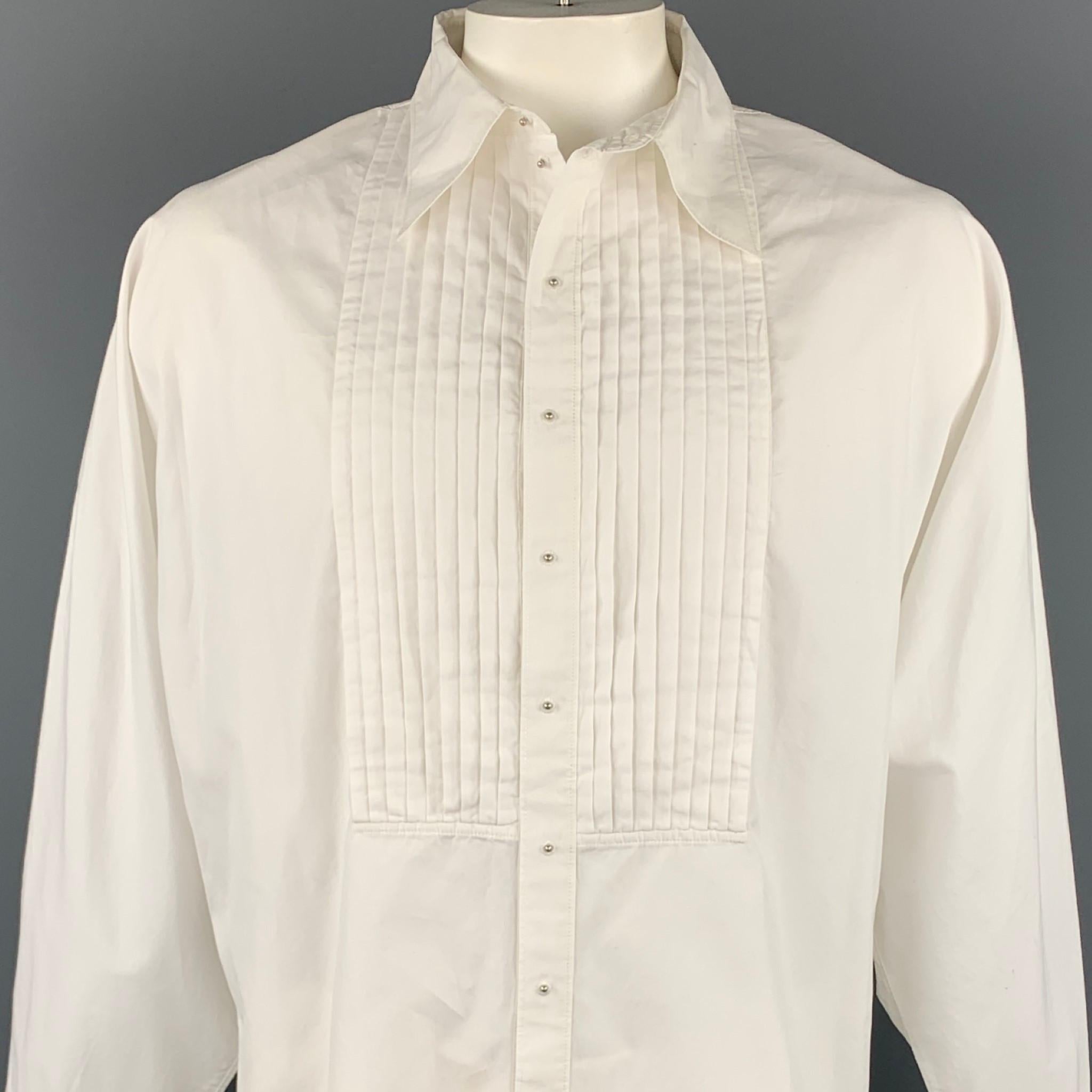 Vintage JEAN PAUL GAULTIER long sleeve shirt comes in a white cotton with front pleats featuring a wing sleeve design, spread collar, and a buttoned stud closure. Moderate wear. Made in Italy.

Good Pre-Owned Condition.
Marked: