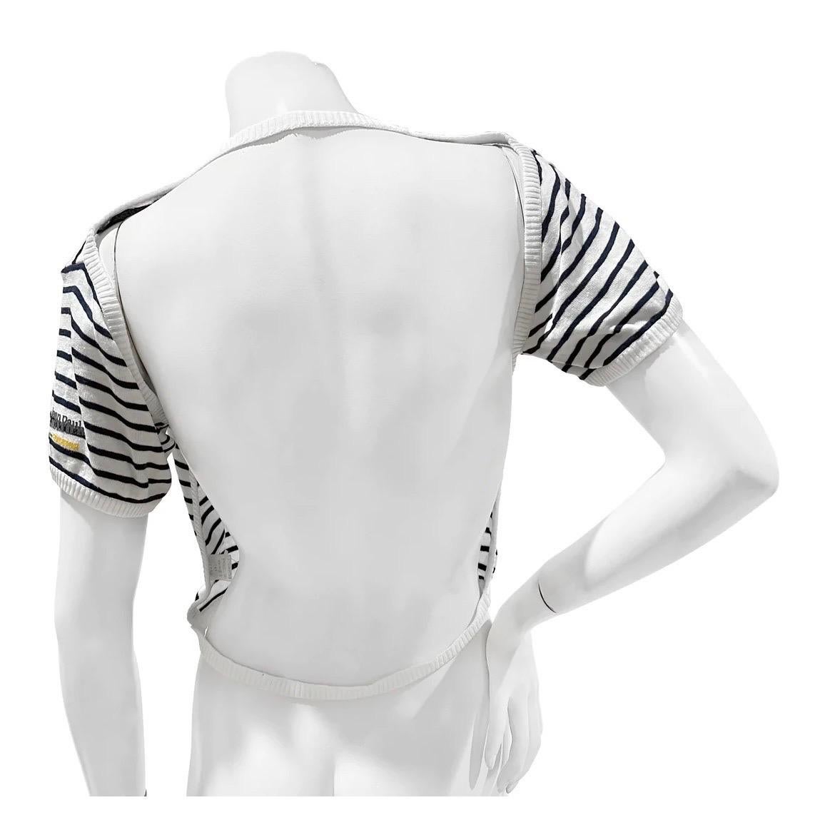 Vintage Striped Backless Cotton Shirt by Jean Paul Gaultier Equator
Circa 1987
Made in Italy
Navy and white stripes
Backless
Short-sleeve 
Ribbed collar, cuffs and waist
Jean Paul Gaultier Logo on left sleeve 
Fabric Composition; 100%