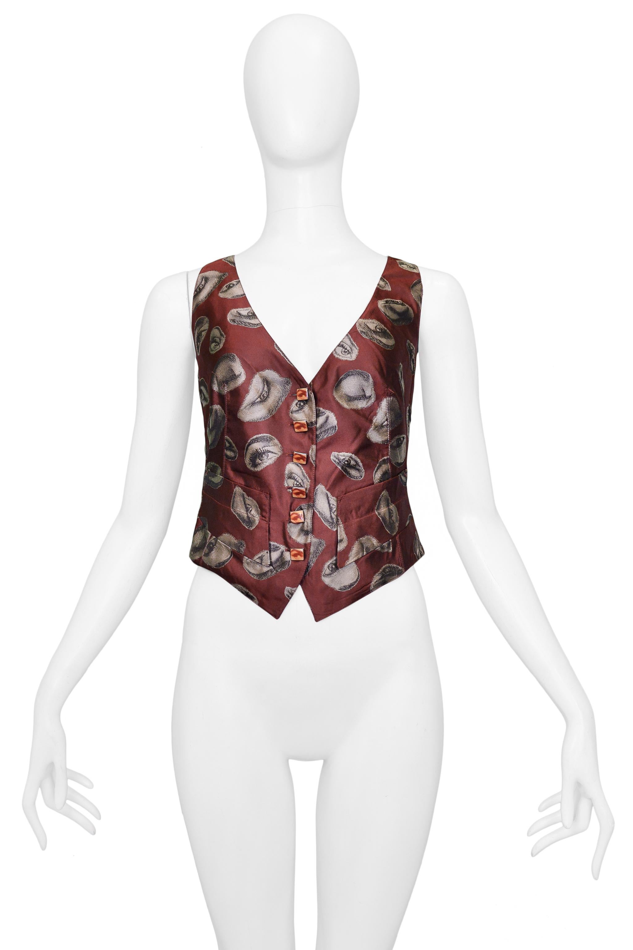 Resurrection Vintage is excited to present a vintage Jean Paul Gaultier burgundy vest featuring a surrealist-inspired eye print, photographic eye buttons, black back panel, adjustable back, and front pockets. 

Jean Paul Gaultier
Size: 42
Silk