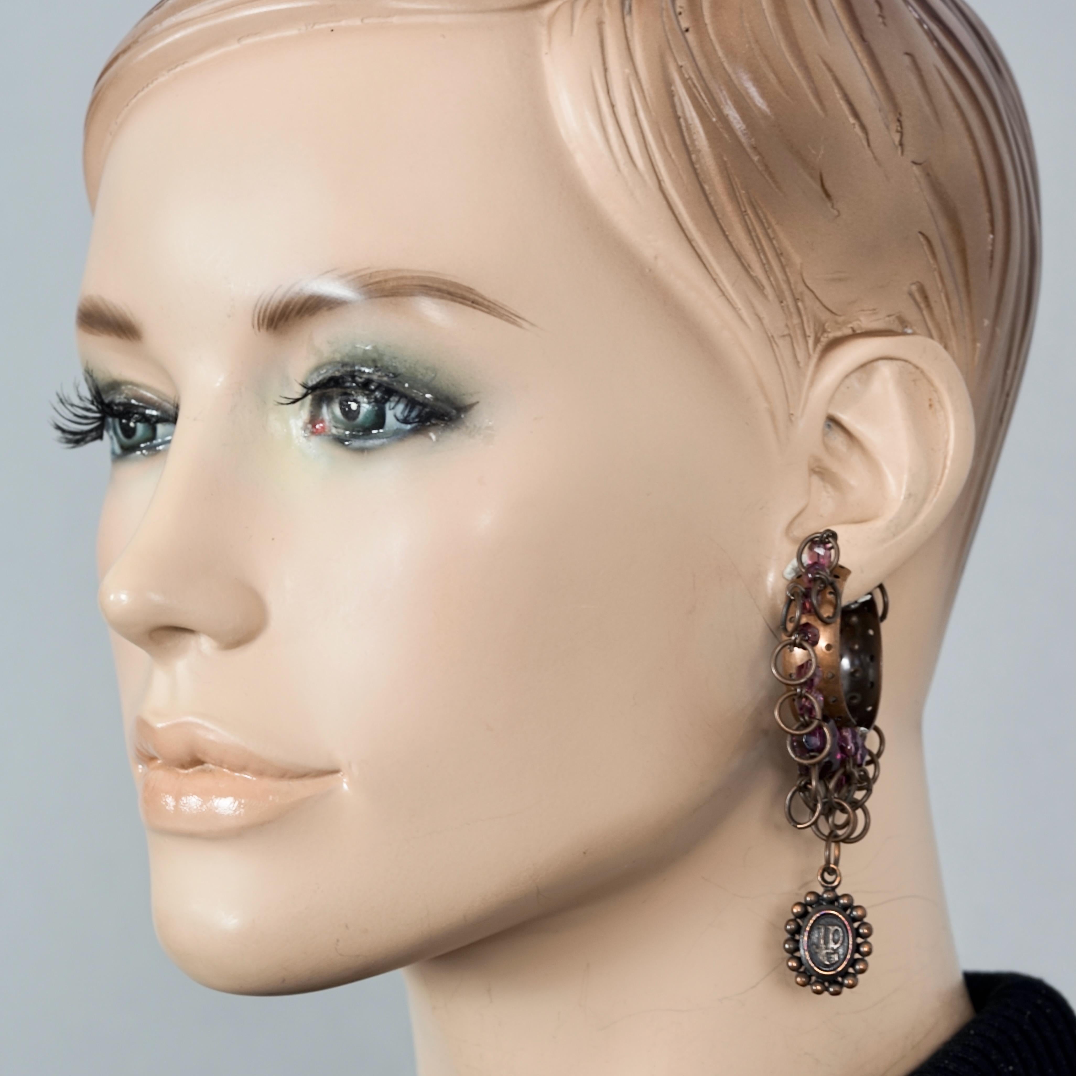 Vintage JEAN PAUL GAULTIER Tribal Creole Beaded Earrings

Measurements:
Height: 3.15 inches (8 cms)
Diameter: 1.97 inches (5 cms)
Weight per Earring: 16 grams

Features:
- 100% Authentic JEAN PAUL GAULTIER.
- Creole earrings in tribal motif with