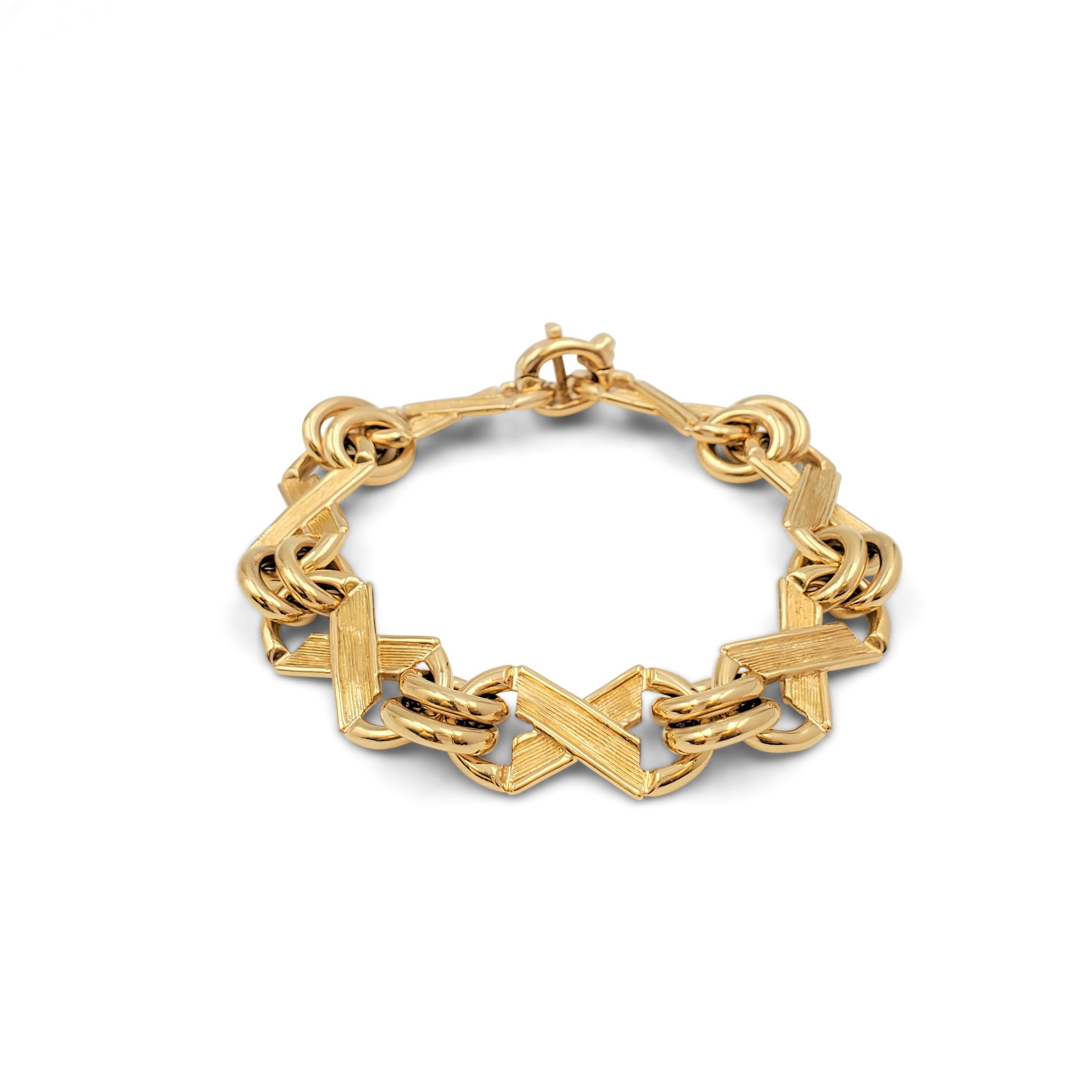 Authentic vintage Jean Schlumberger for Tiffany & Co. bracelet crafted in 18 karat yellow gold features a charming x and o motif created by textured links and smooth round connectors. Signed Tiffany & Co., Schlumberger, 750. The bracelet is not
