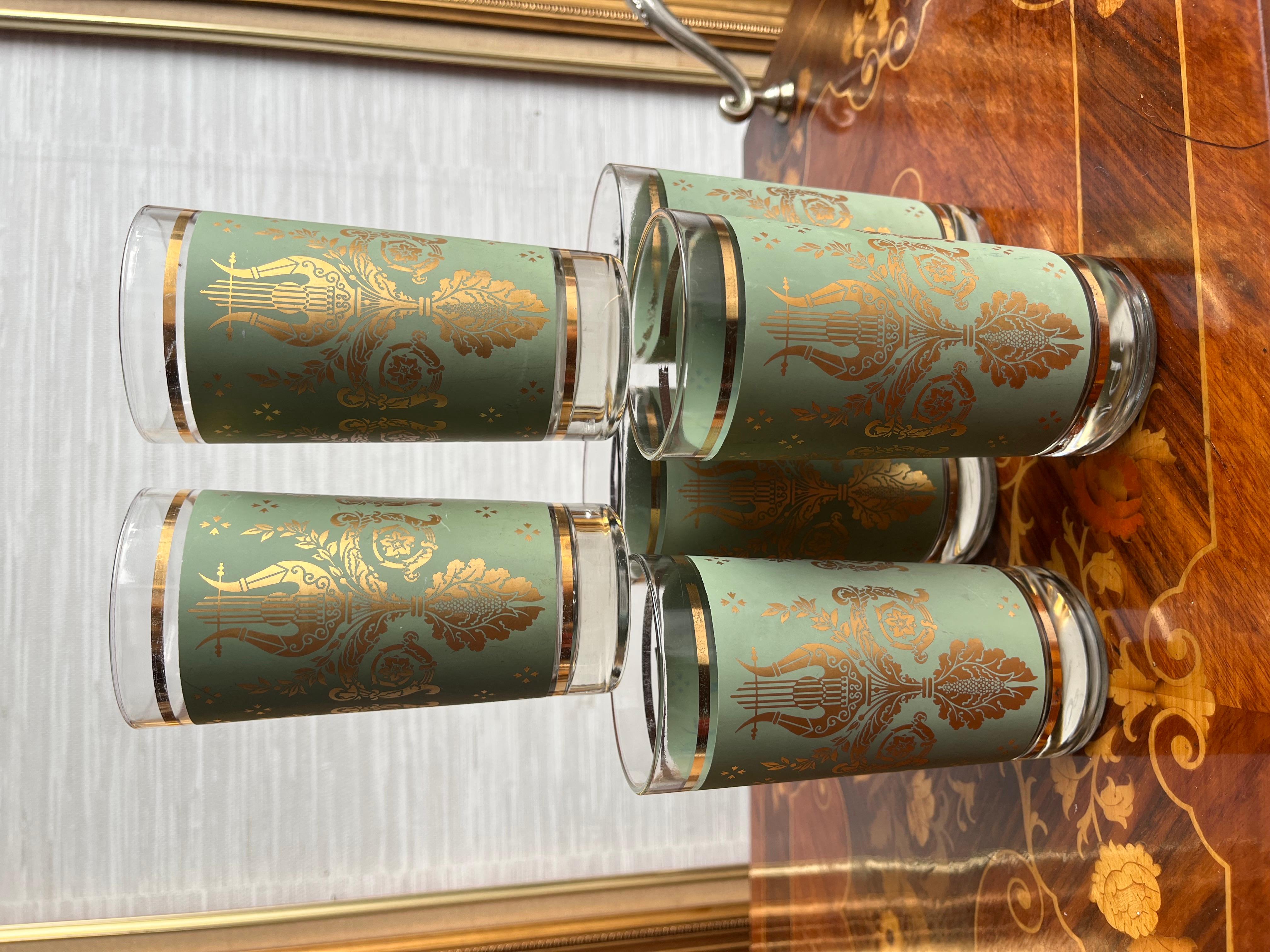 Indulge in the timeless allure of mid-century elegance with this stunning set of 6 vintage Jeanette Glass Green and Gold Laurel and Lyre cocktail glasses. Each glass features a captivating design of green and gold laurel leaves and lyres, evoking a