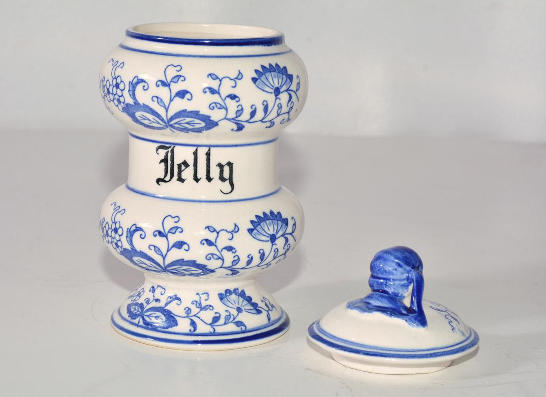 The blue floral and white canister jar with lid is stamped Jelly.