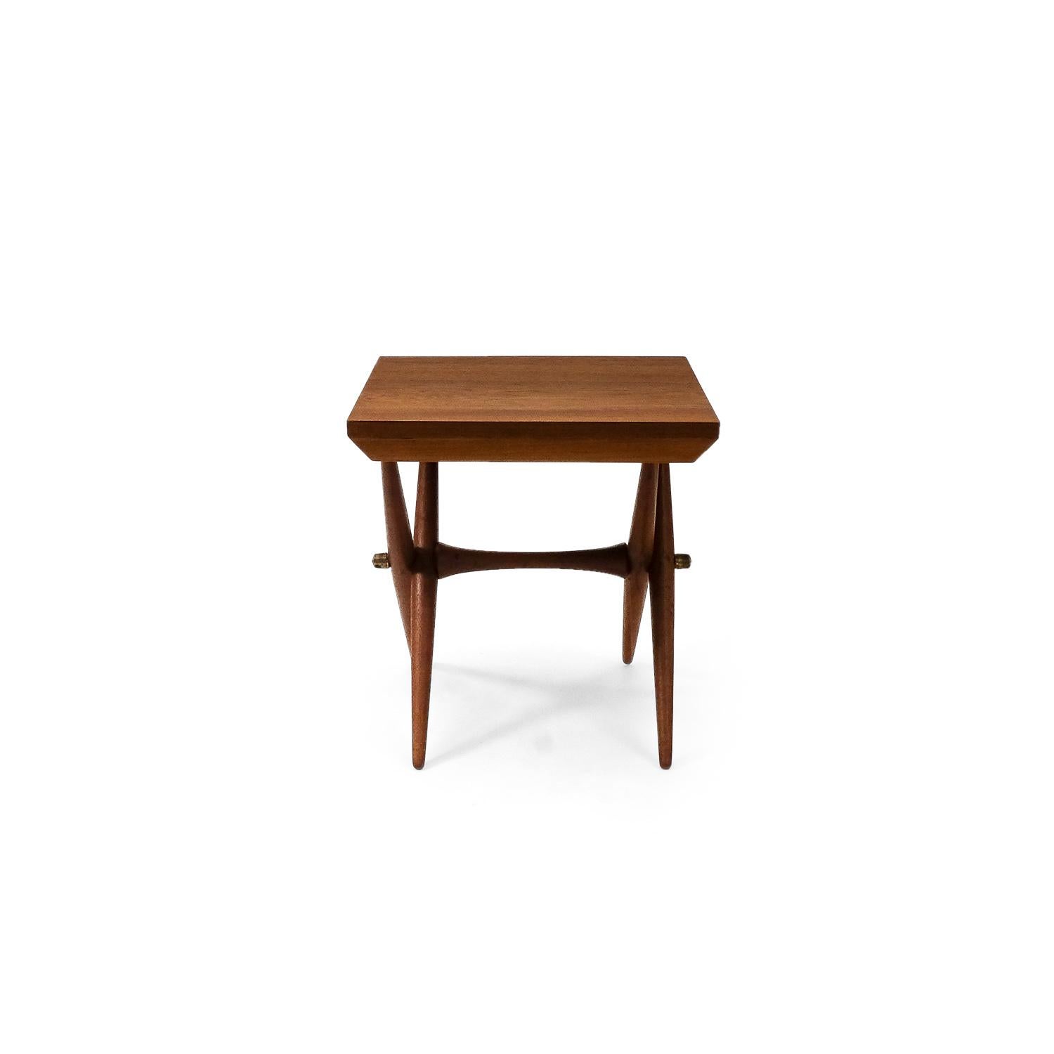 A foldable side or occasional table by Jens Harald Quistgaard.

This practical and elegant side table is in excellent condition, it features brass fittings and is made of solid teak. Stamped below tabletop. We have refinished the tabletop and