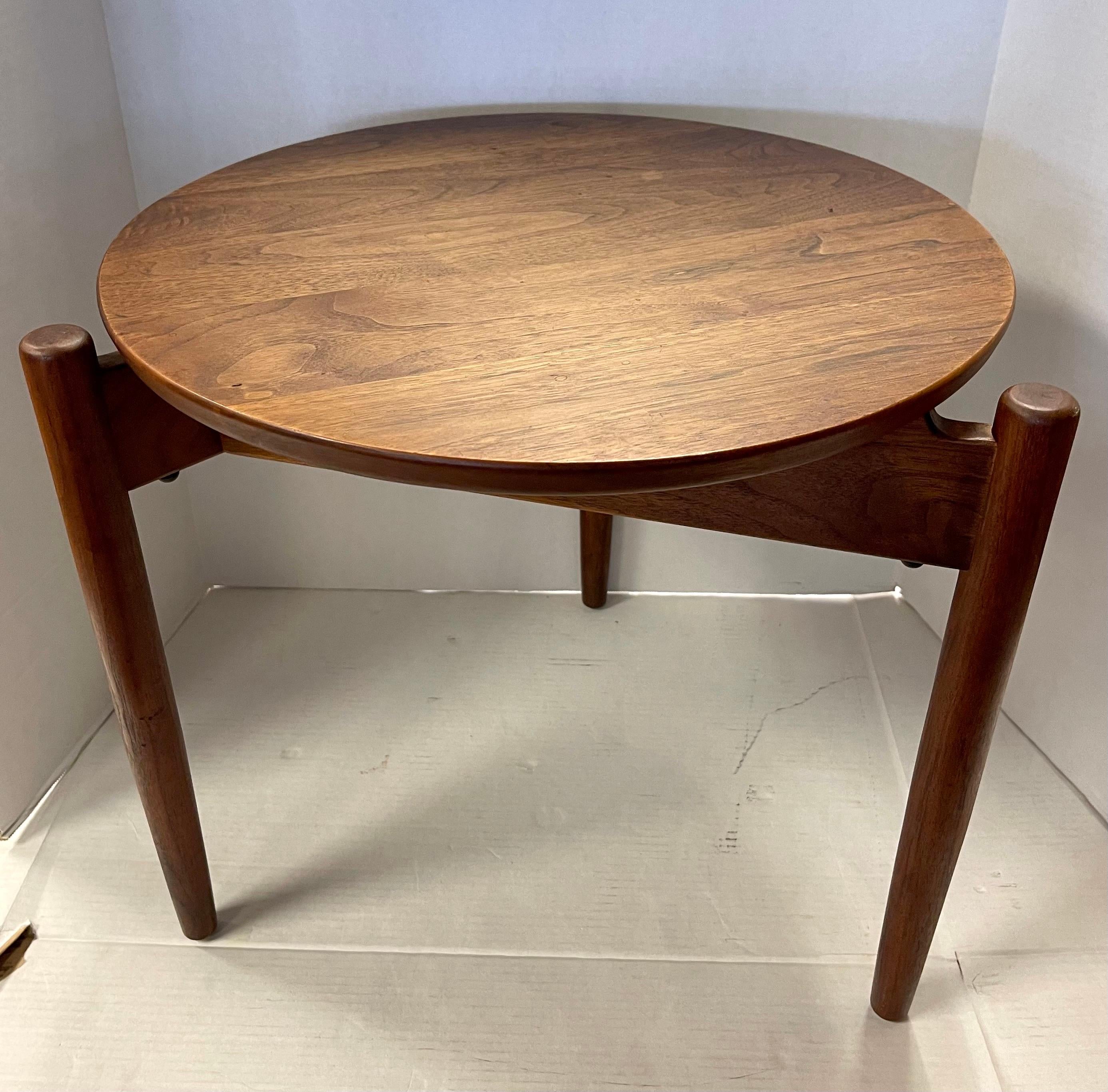 This stunning Jens Risom design round side/end/occasional table is constructed from beautiful Mid-Century teak. Iconic yet practical Danish design makes this a stunning table perfect for home or business use. Three leg design is complimented by