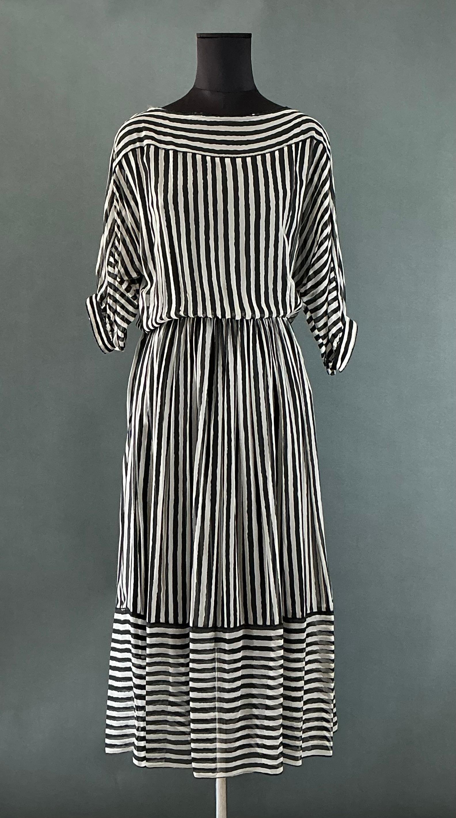 This Vintage Jeri Striped Maxi Dress is a striking, retro-inspired piece that embodies the classic elegance and charm of vintage fashion. Known for its bold striped pattern, this dress combines timeless style with flattering cuts, making it a