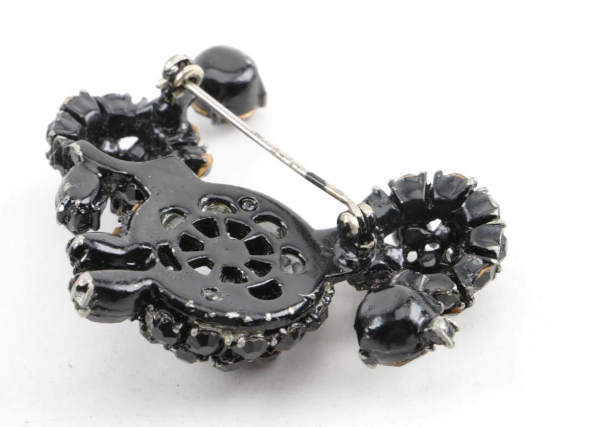 Adorable Jet Bead Poodle Brooch from the 1940s.
Various size faceted stones on a black enamel metal frame setting to create the perfect structure for this most adorable poodle, skillfully designed and fabricated.

For the poodle lover, and who