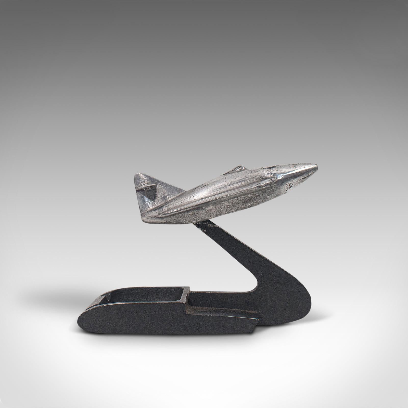 This is a vintage jet plane on stand. An English, cast alloy decorative desk ornament, dating to the early days of the jet age in the mid-20th century, circa 1960.

Oversee bombing raids at your desk with this wonderful jet
Displays a desirable