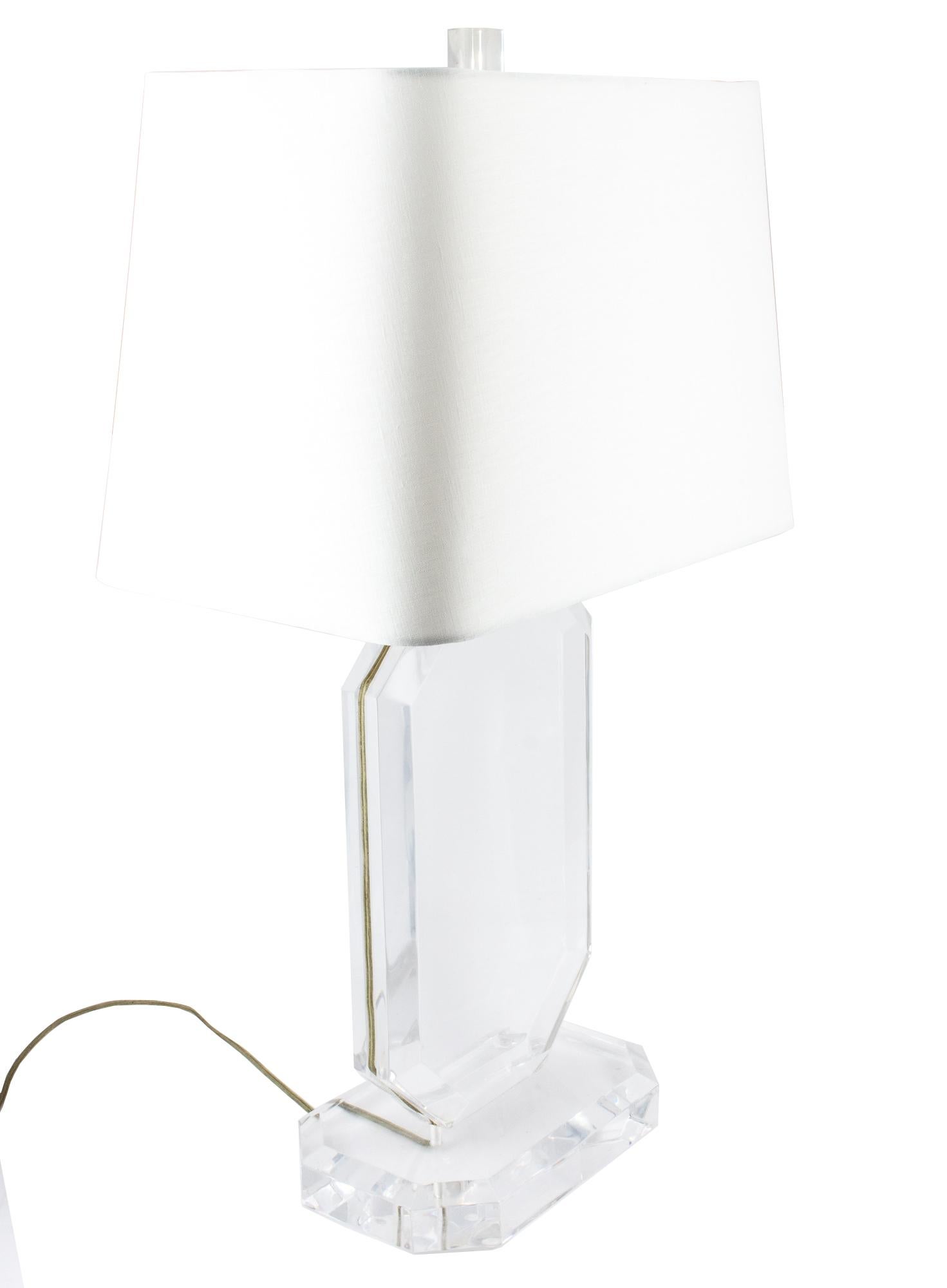 A truly lovely pairing of midcentury Lucite acrylic lamps, a pairing of two are being offered and have beveled edging creating a jewel like look. Stylish in almost any interior space, the rounded linen shade is a new addition in a soft white color,