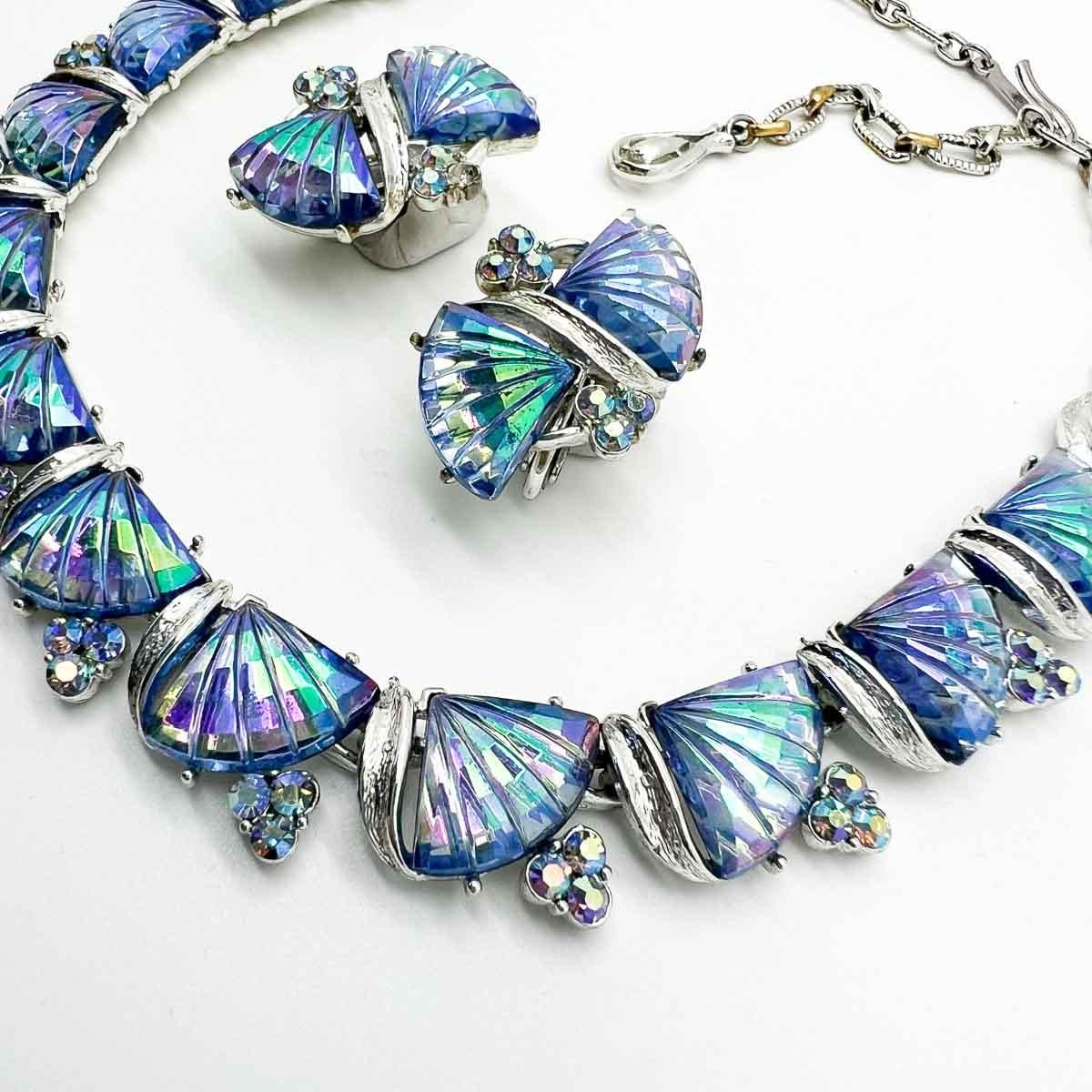 A Vintage Jewelcraft Fan Necklace and earrings creating the most mesmerising set of mid-century jewels. The aurora borealis finish and stylised floral motif stones creating a dreamy current vibe despite their seventy-year life.  Jewelcraft was a
