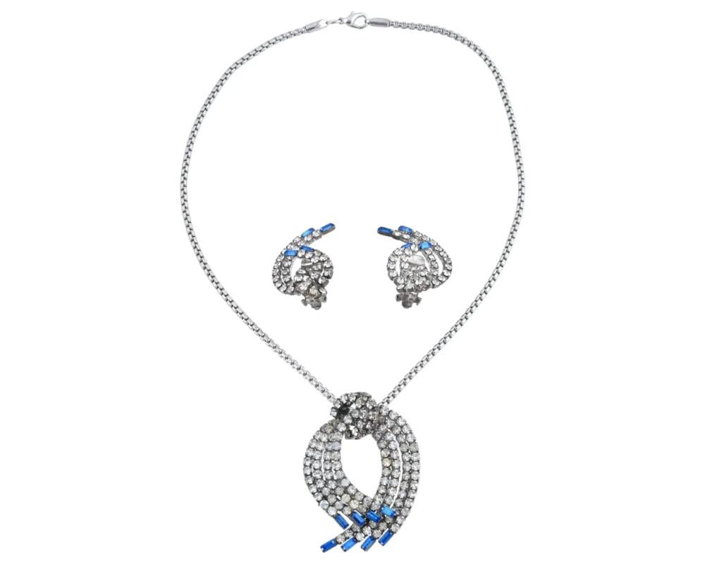 A vintage two-piece costume jewelry set, a chain necklace and a pair of clip-on earrings. Silver-tone metal jewelry with cubic zirconia and baguette-cut blue glass stones. Unmarked. Collectible Bijoux, Statement Jewelry For Women.

Dimensions: