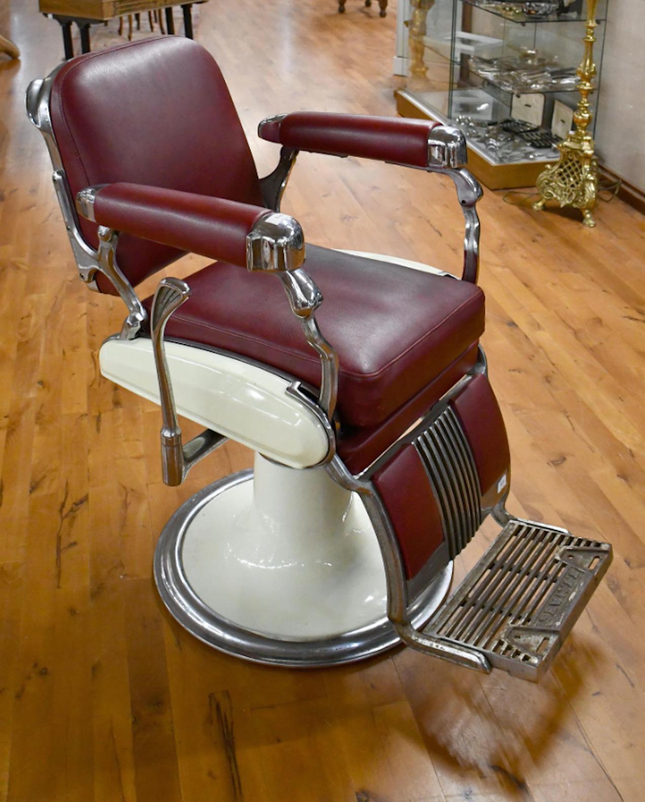 Vintage J.J. Maes fauteuil de barbier recently reupholstered in dark red leather. Circa 1950
