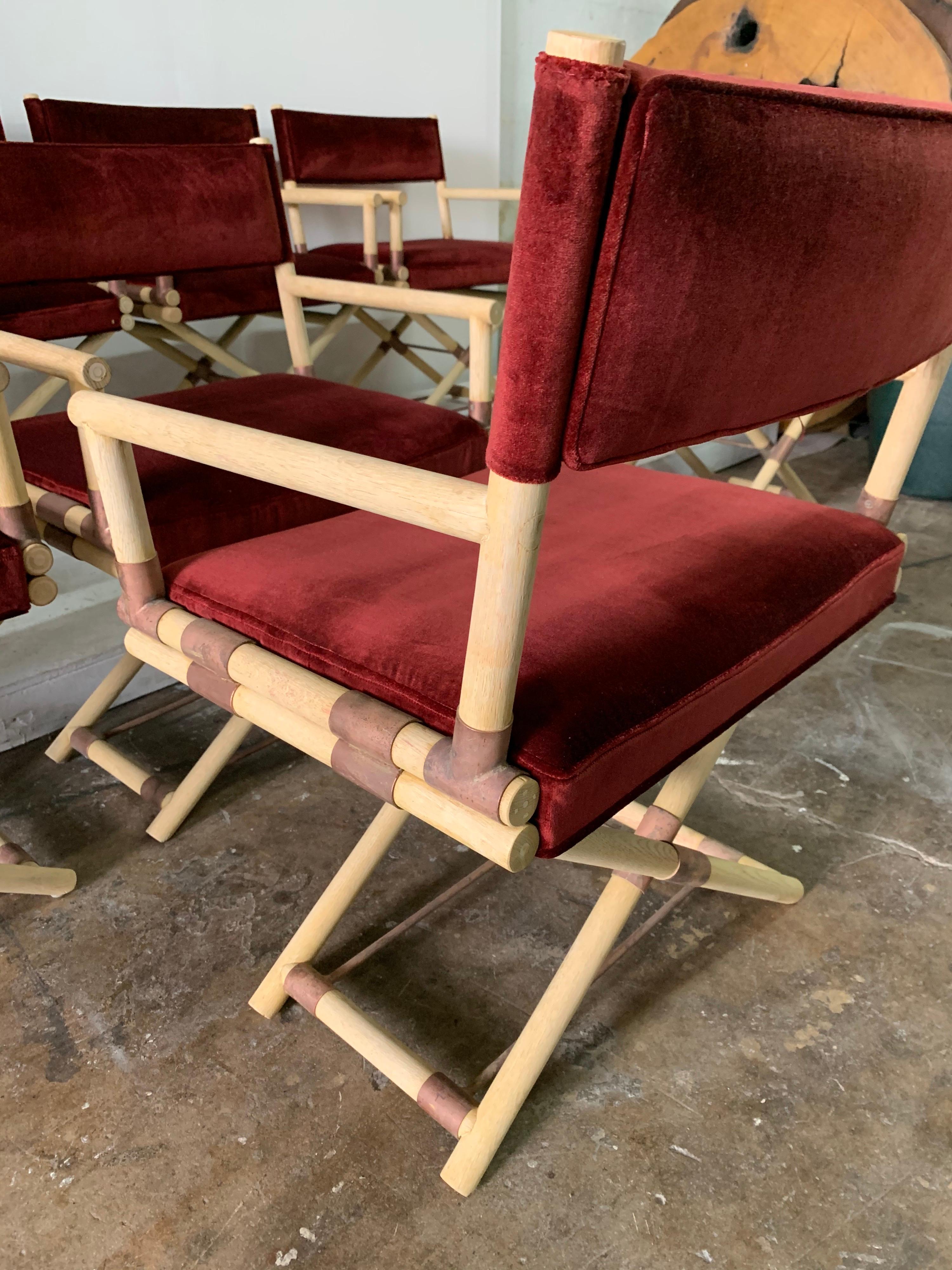 All armchairs these Classic Director style chairs in bleached unfinished wood, keeping a rustic and beautiful natural look. Rustic copper finish joints. Overall a great grouping, solid and recently upholstered in burgundy cotton velvet fabric. These