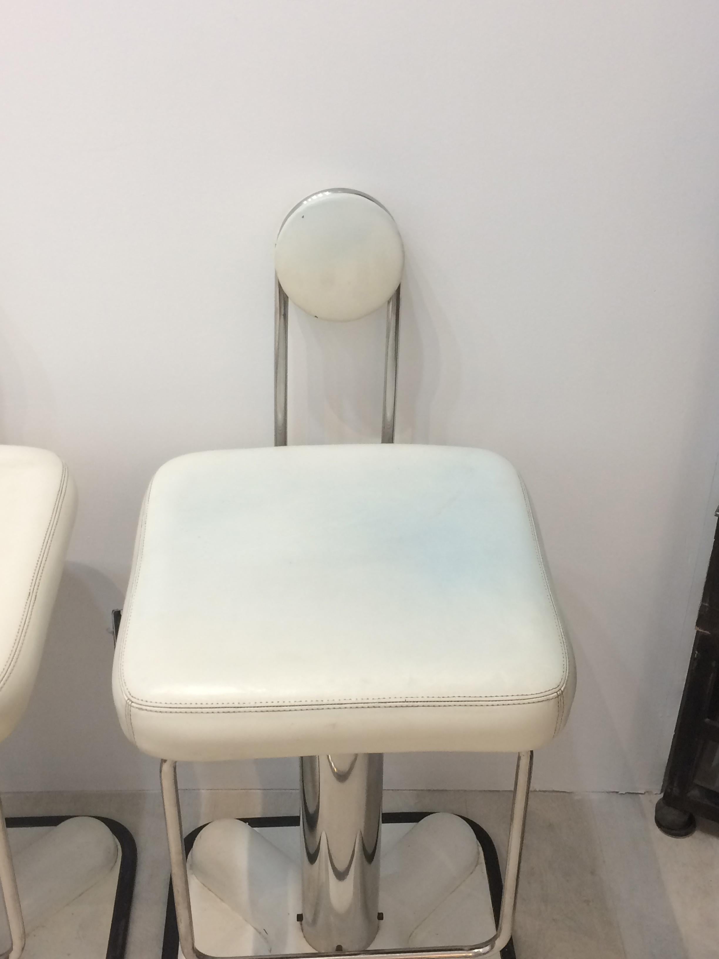 Birillo barstools were designed in 1971 by Joe Colombo for Zanotta. White upholstery on chromed metal base with a white lacquered plastic foot. An award winning design by Joe Colombo one of the premier 1960s furniture designers.
