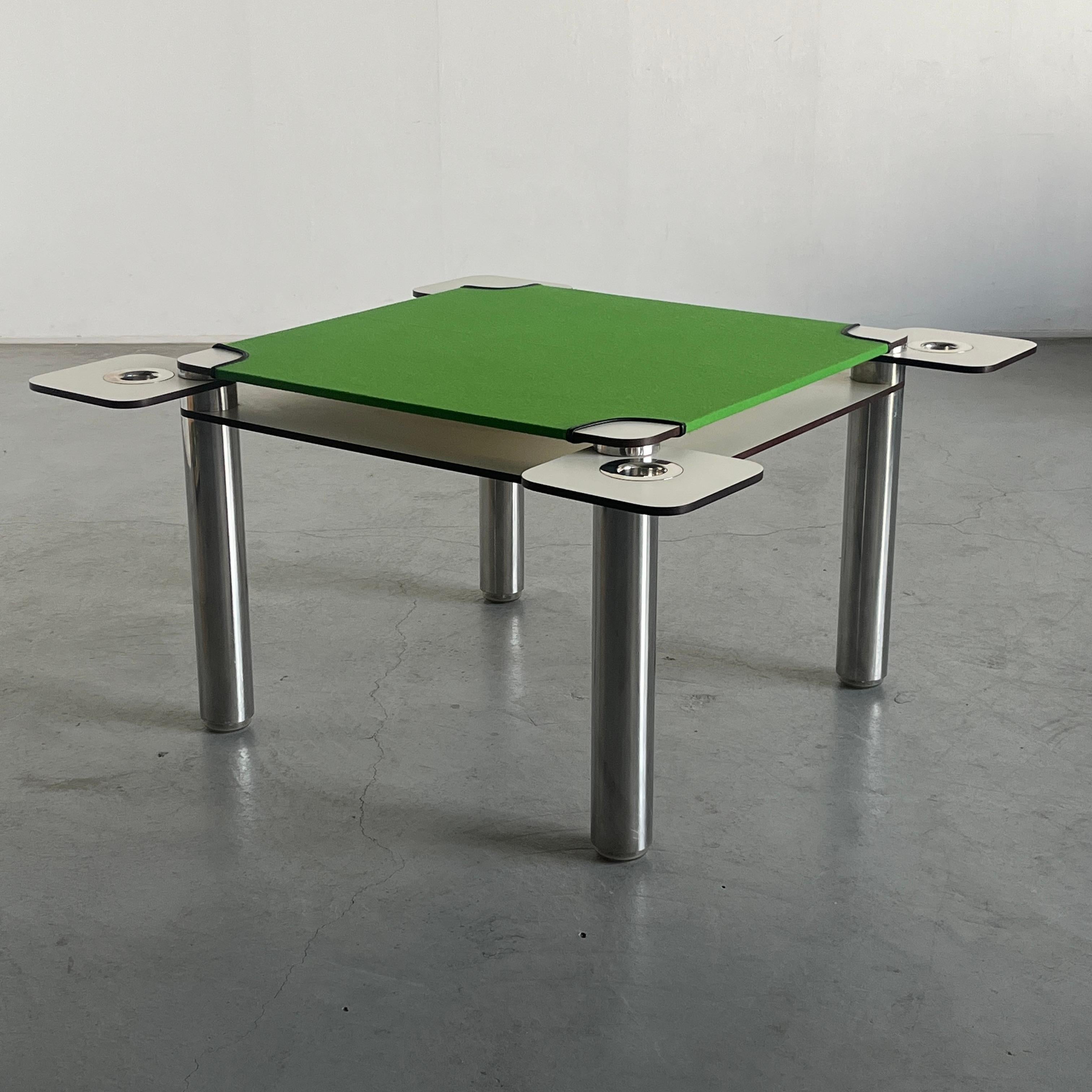 Iconic vintage poker table designed by renowned designer Joe Colombo for Italian manufacturer Zanotta in 1968. The vibrant poker table features chromed steel ashtrays which pull out to the sides on each corner, a feature which has since abandoned in