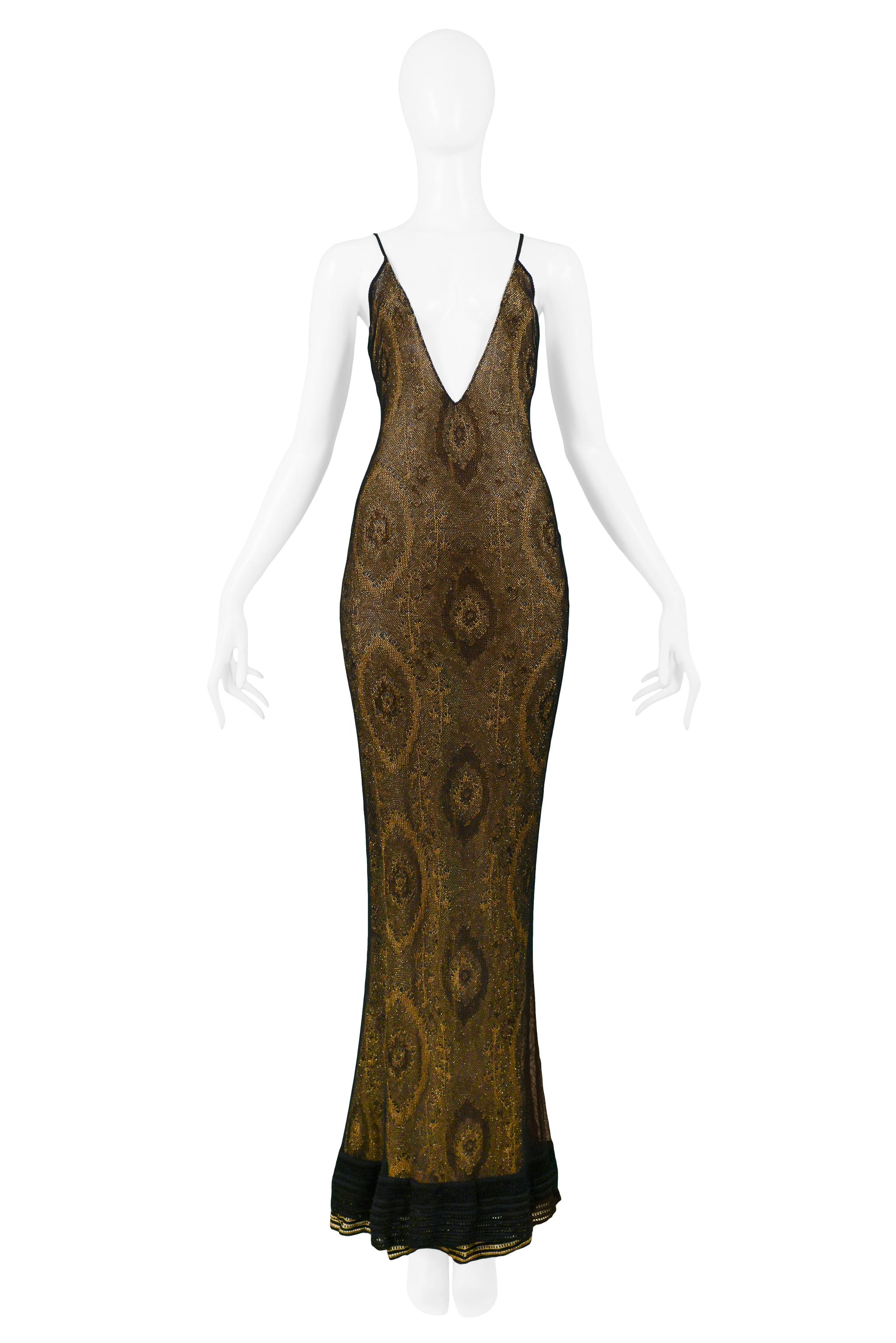 We are excited to offer this vintage John Galliano gold lame netted evening ensemble featuring a form-fitting mermaid evening gown with plunging neckline and back, skinny straps, and black ribber trim at the hem. The dress is offered with a matching