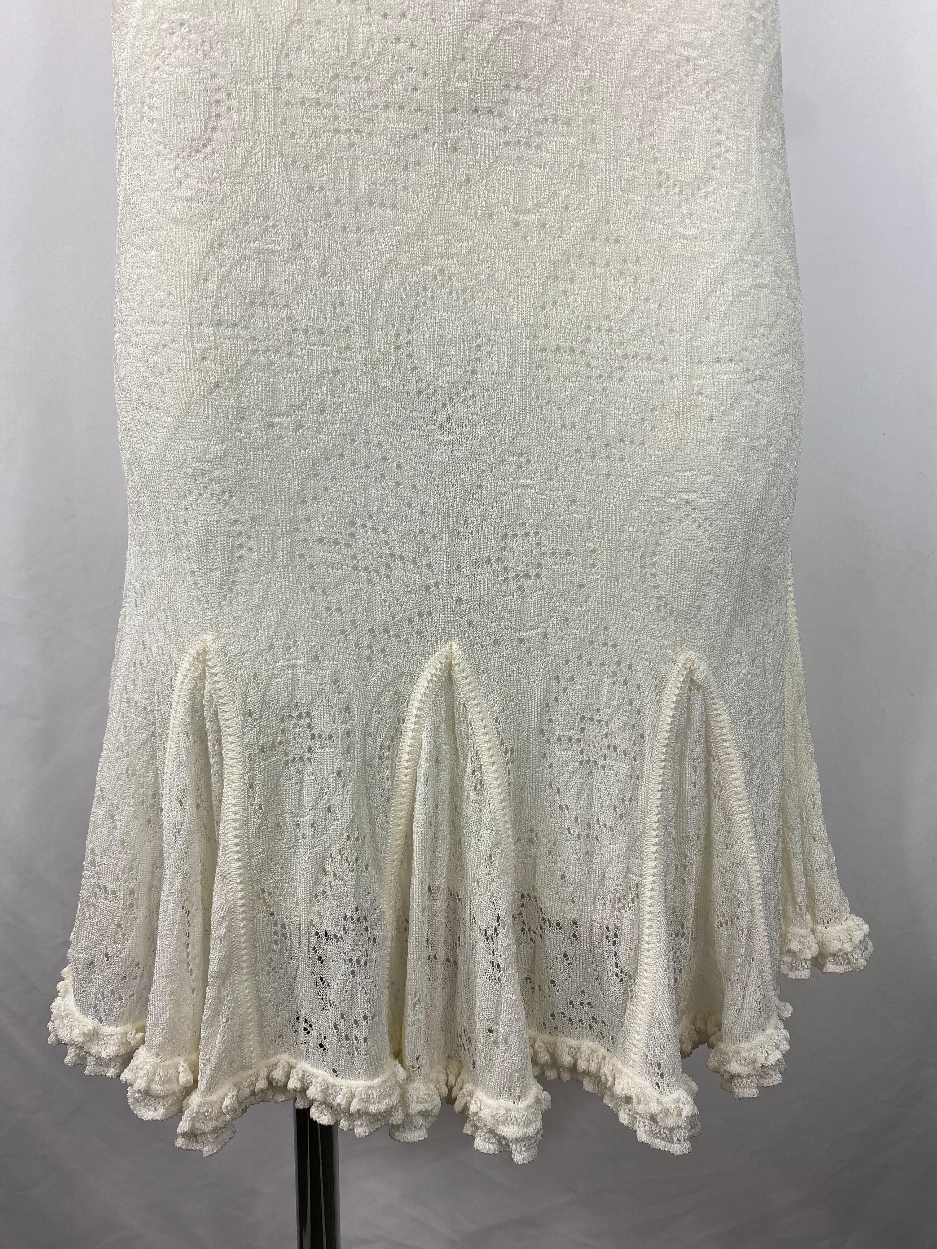 Product details:

White lace dress designed by John Galliano. The dress features v neck line with buttons detail on the front, sleeveless with straps and mid length. Missing tags.