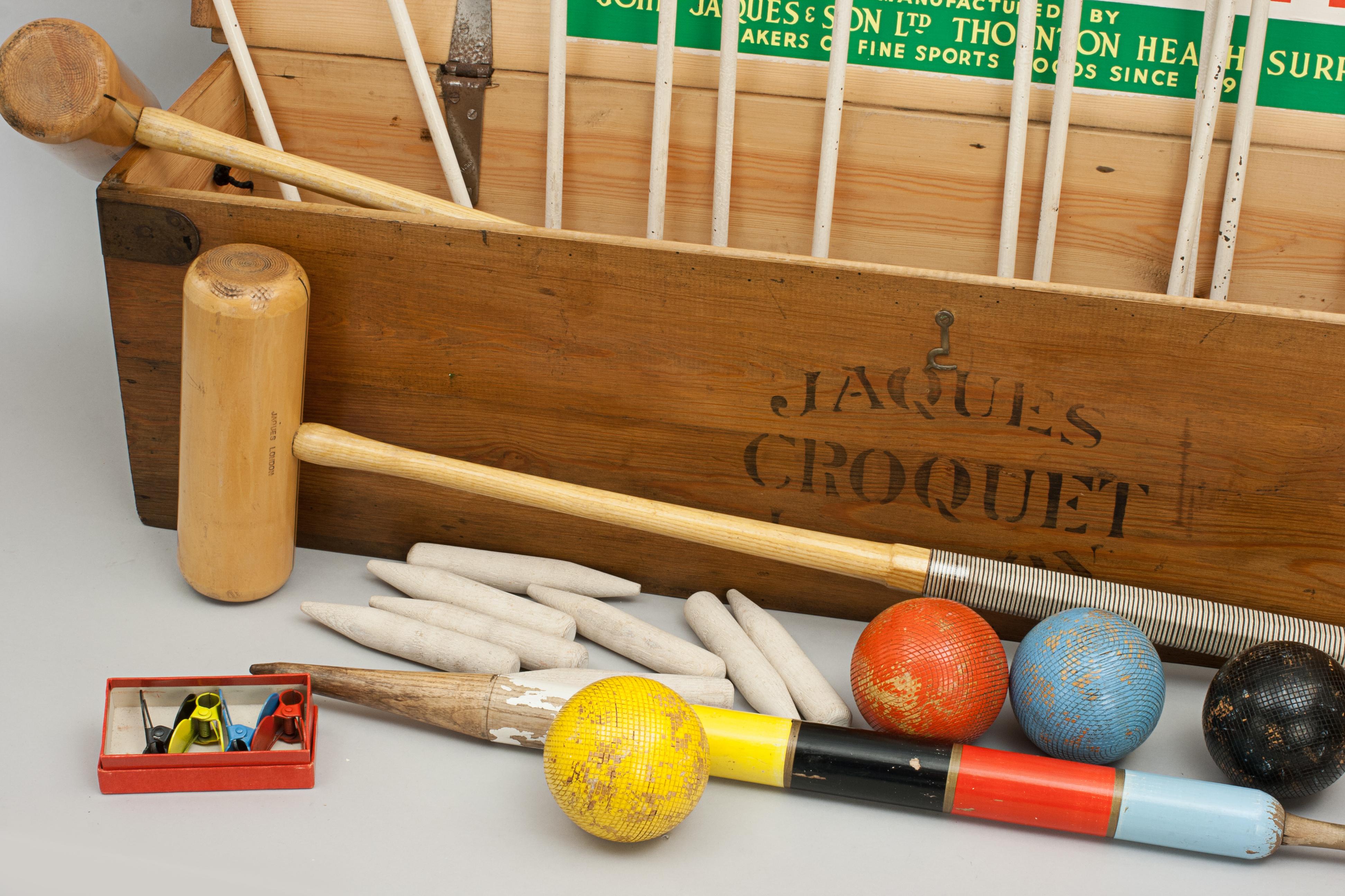 Vintage John Jaques Croquet set.
A good quality Jaques croquet set in original pine box with Jaques' name painted onto the front and lid. It is with four box wood mallets with guide lines on the tops of the heads and octagonal handles with cord