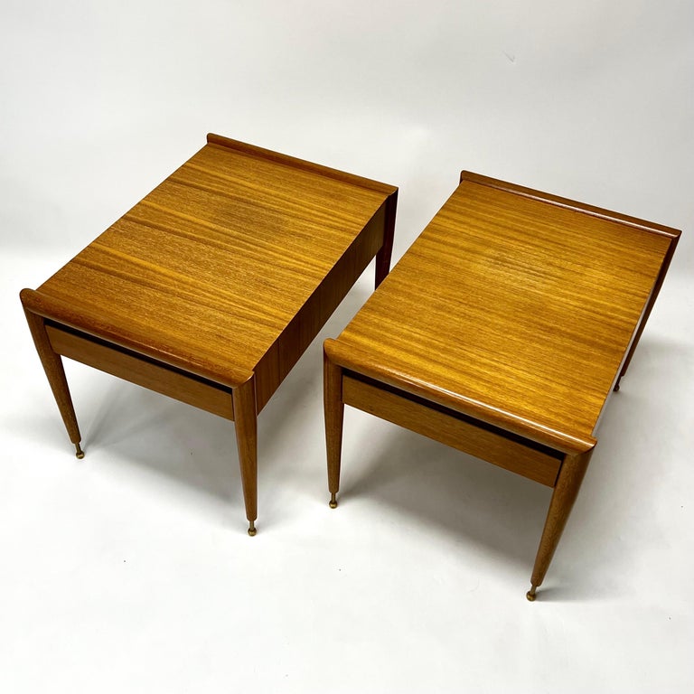 Stunning and rare pair of side tables in bleached mahogany designed by John Keal for Brown Saltman c1950s. Amazing design, both with a single drawer. Brass legs with original Bakelite ball feet. Probably one of his most sought after designs.