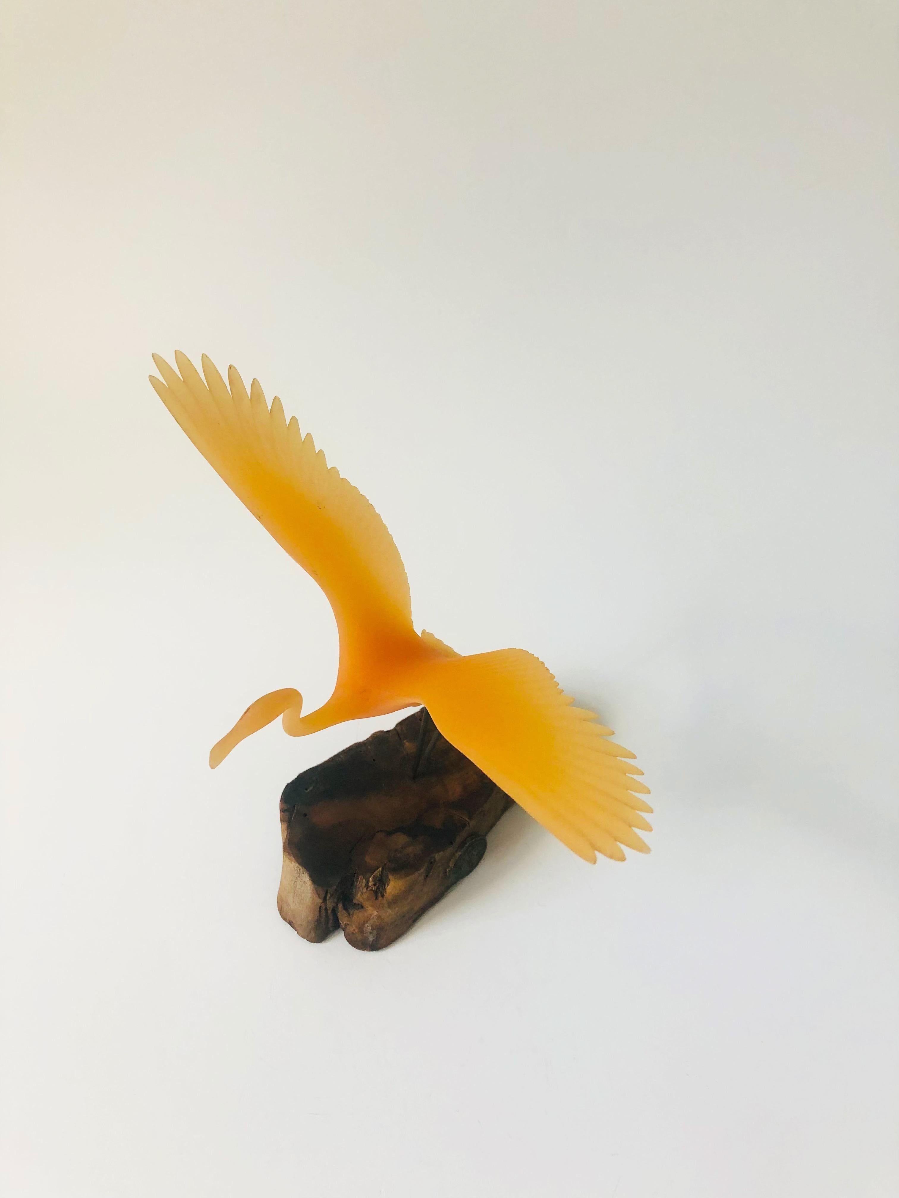 A wonderful vintage sculpture by John Perry. Features a peach colored resin flamingo mounted to a burlwood base. Marked by John Perry's signature plaque on the base.
 