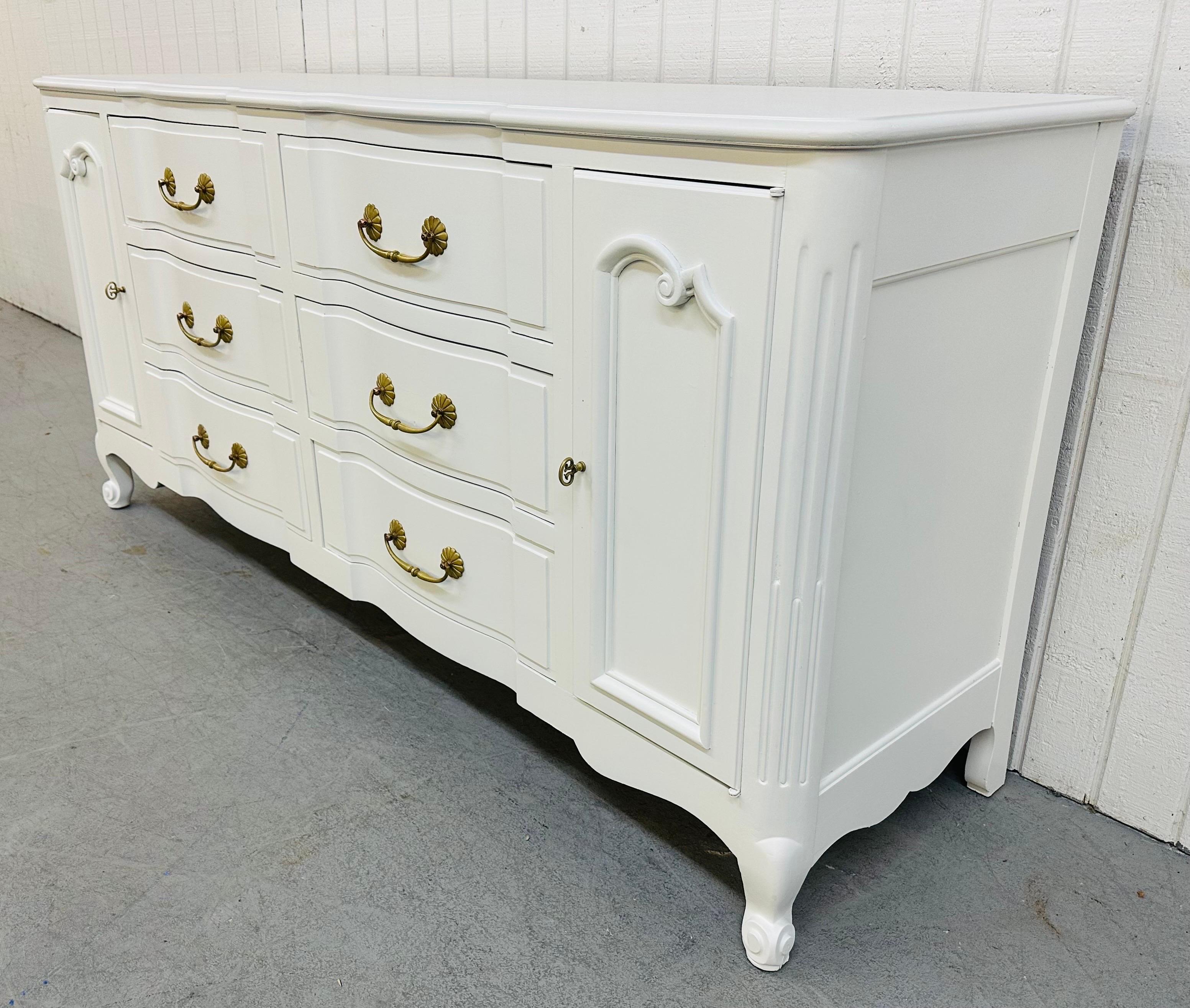 This listing is for a Vintage John Stuart French Provincial Painted White Dresser. Featuring six large center drawers, six smaller drawers hidden behind doors, original brass hardware, exceptional quality by John Stuart, and a newly painted finish.